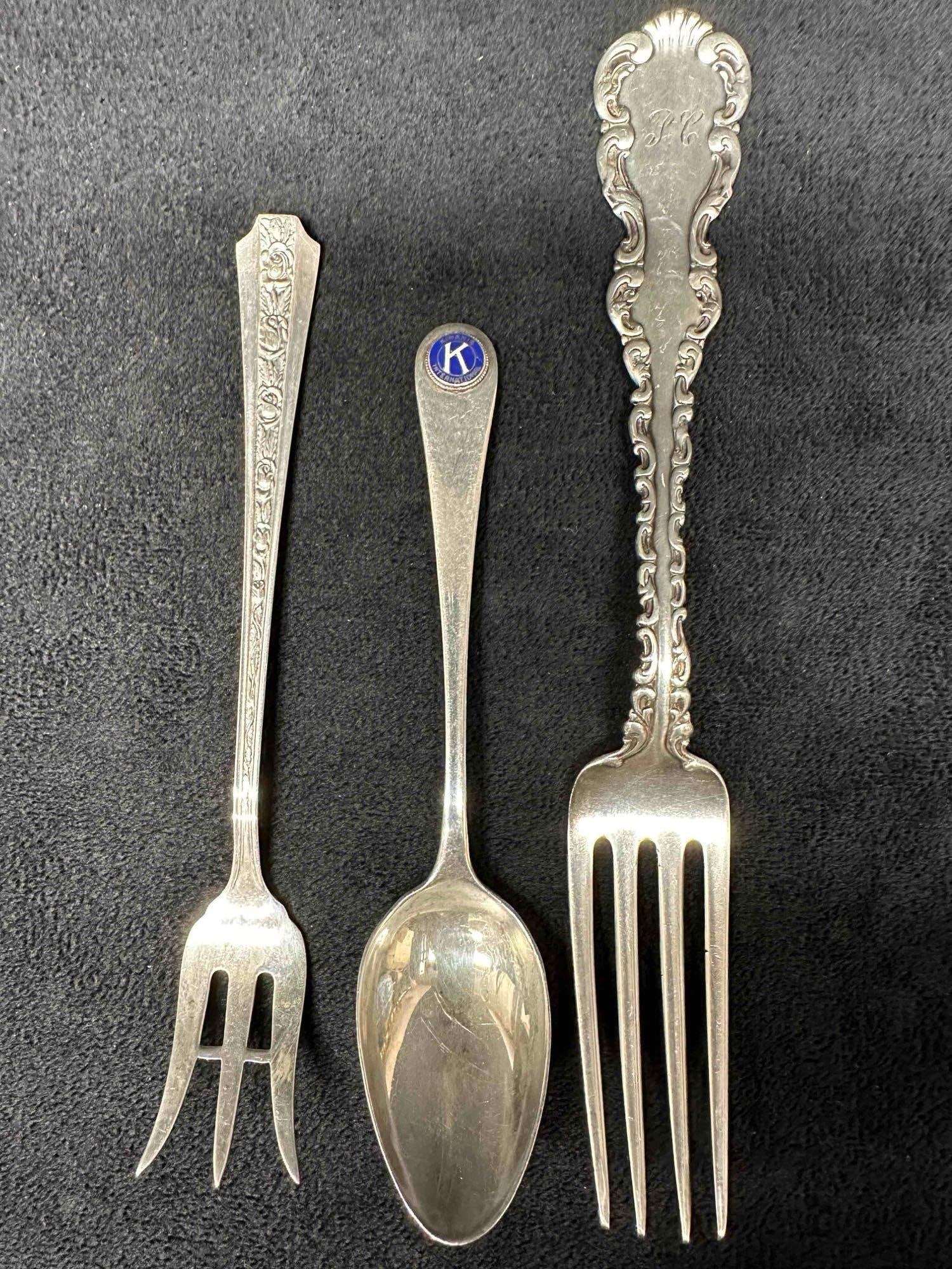 Various Sterling Silver Silverware Kiwanis International Spoon Dinner Fork Cocktail Fork Set of 3: Various Sterling Silver Silverware Kiwanis International Spoon Dinner Fork Cocktail Fork Set of 3. Each piece has a unique design with the cocktail fork featuring roses, the dinner fork has ribbed des