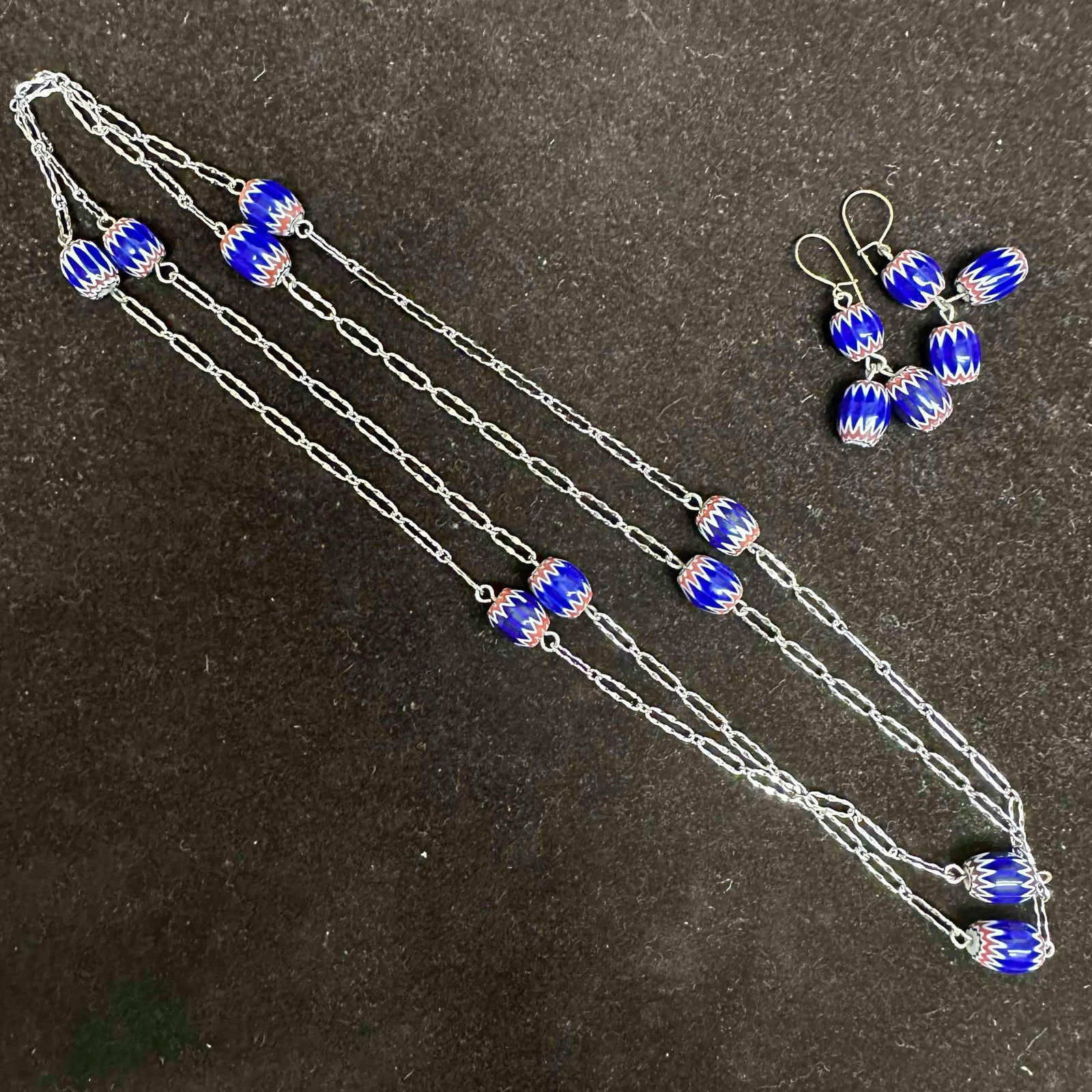 African Style Blue Red White Colored Chevron Bead Necklace and Earring Set G6: This costume jewelry set features a matching pair of earrings and necklace with blue, red, and white colored chevron beads. These items are in good pre-owned, previously displayed condition with light