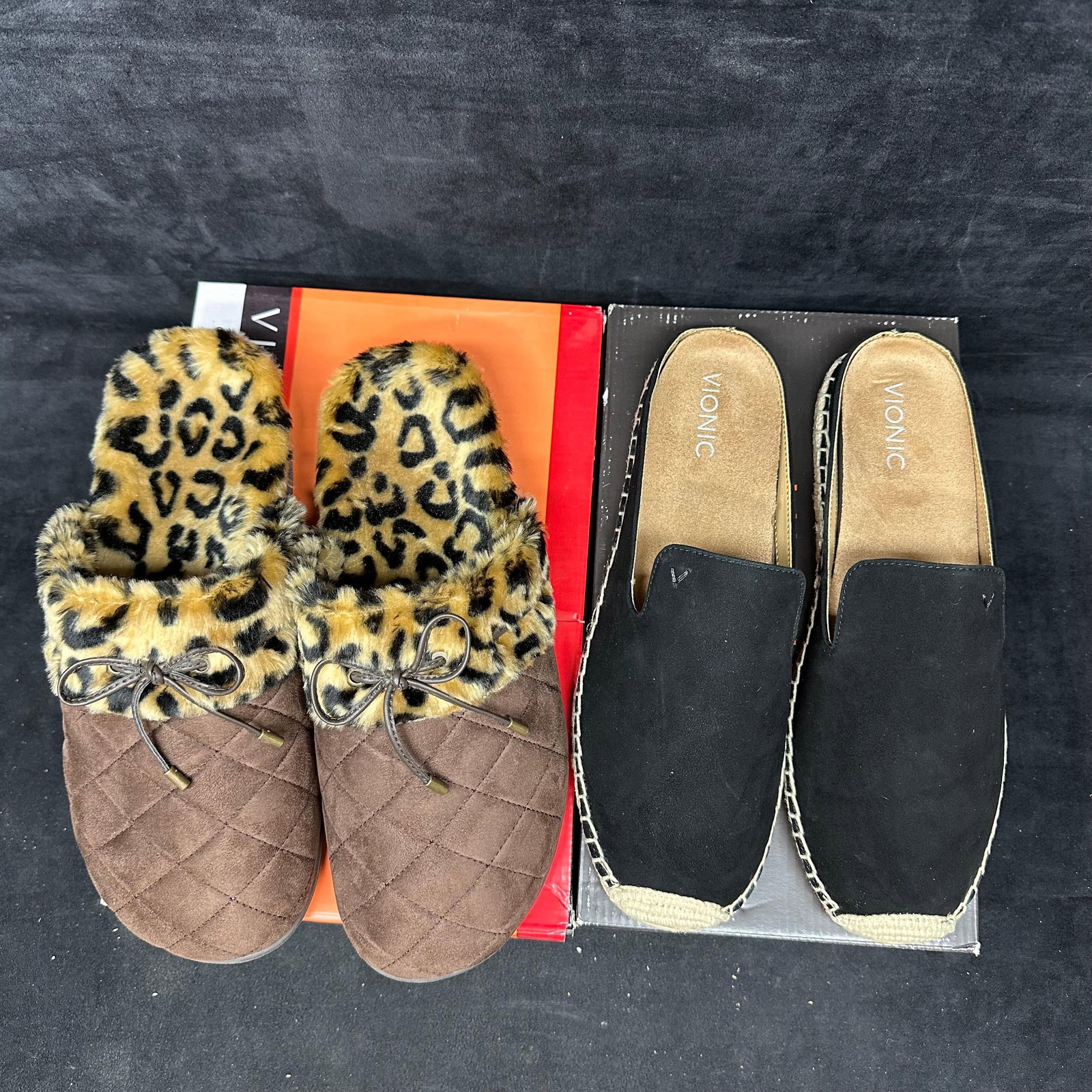Women's Vionic Slip-On Shoes Two Pairs Leopard Print: Pair of women’s Vionic shoes, including quilted faux suede slippers with leopard print lining and black suede espadrille slip-ons. All pairs appear lightly worn or unused and include original boxes.