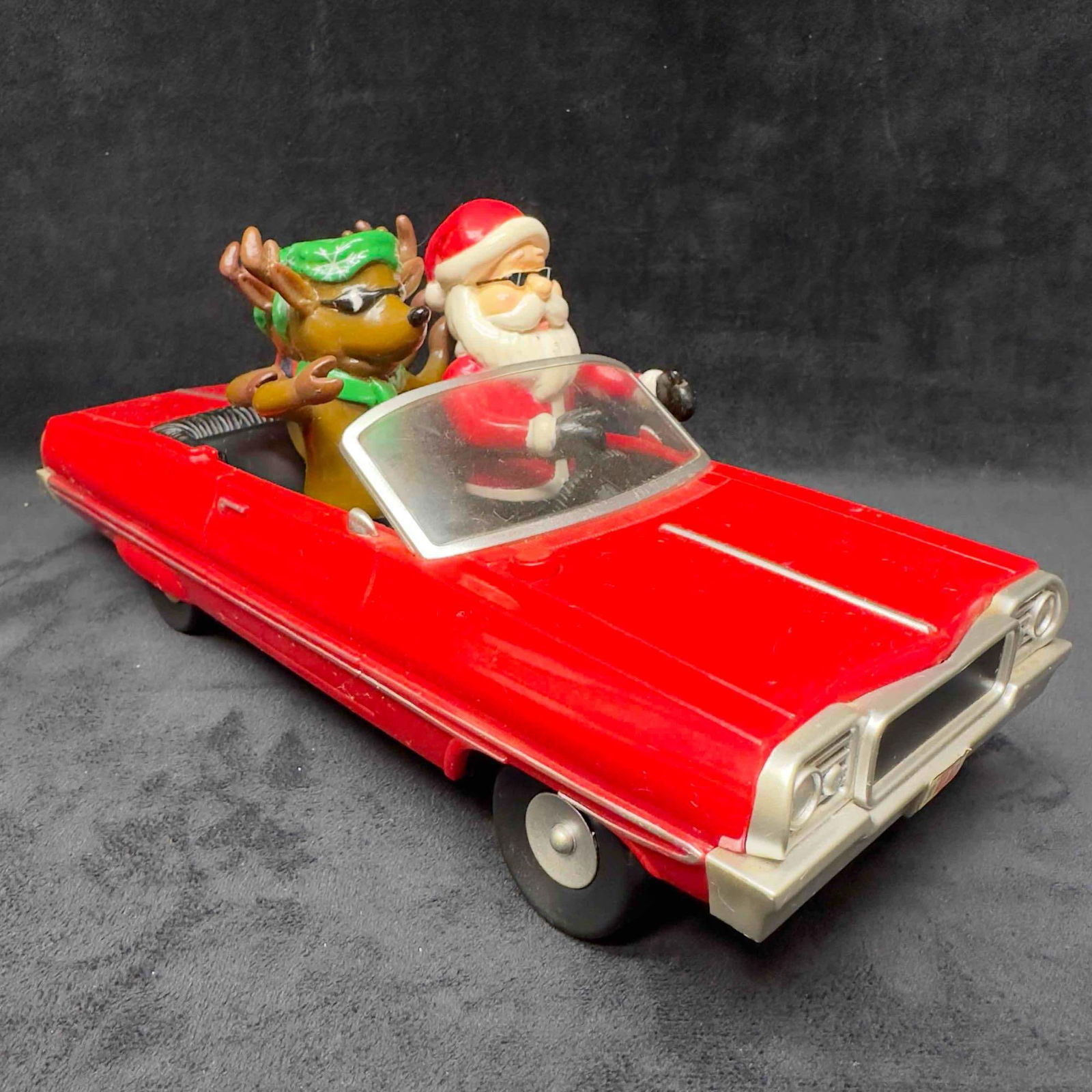 Gemmy Christmas Red Impala Low Rider Car Santa Reindeer Animated Holiday Music Lights: Gemmy Christmas Red Impala Low Rider Car Santa Reindeer Animated Holiday Music Lights. Light wear with surface scratches and the battery compartment is cracked. Music and lights working but animated