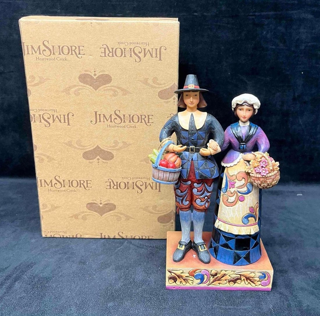 Jim Shore "Pilgrims Proud" Pilgrim Couple Figurine In Original Box: This lot contains a Jim Shore "Pilgrims Proud" Pilgrim Couple Figurine In Original Box. The box is approx 5 1/2" x 7 1/2" x 11 1/2". Total weight is approx 2lbs. Overall the Jim Shore figurine is in