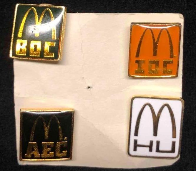 Vintage McDonalds Graduate Pins BOC, HU, IOC & AEC: This lot contains a unique set of vintage McDonalds graduate pins including BOC, (Basic Operations Course) HU, (Hamburger University) IOC (Intermediate Operations Course) & AEC