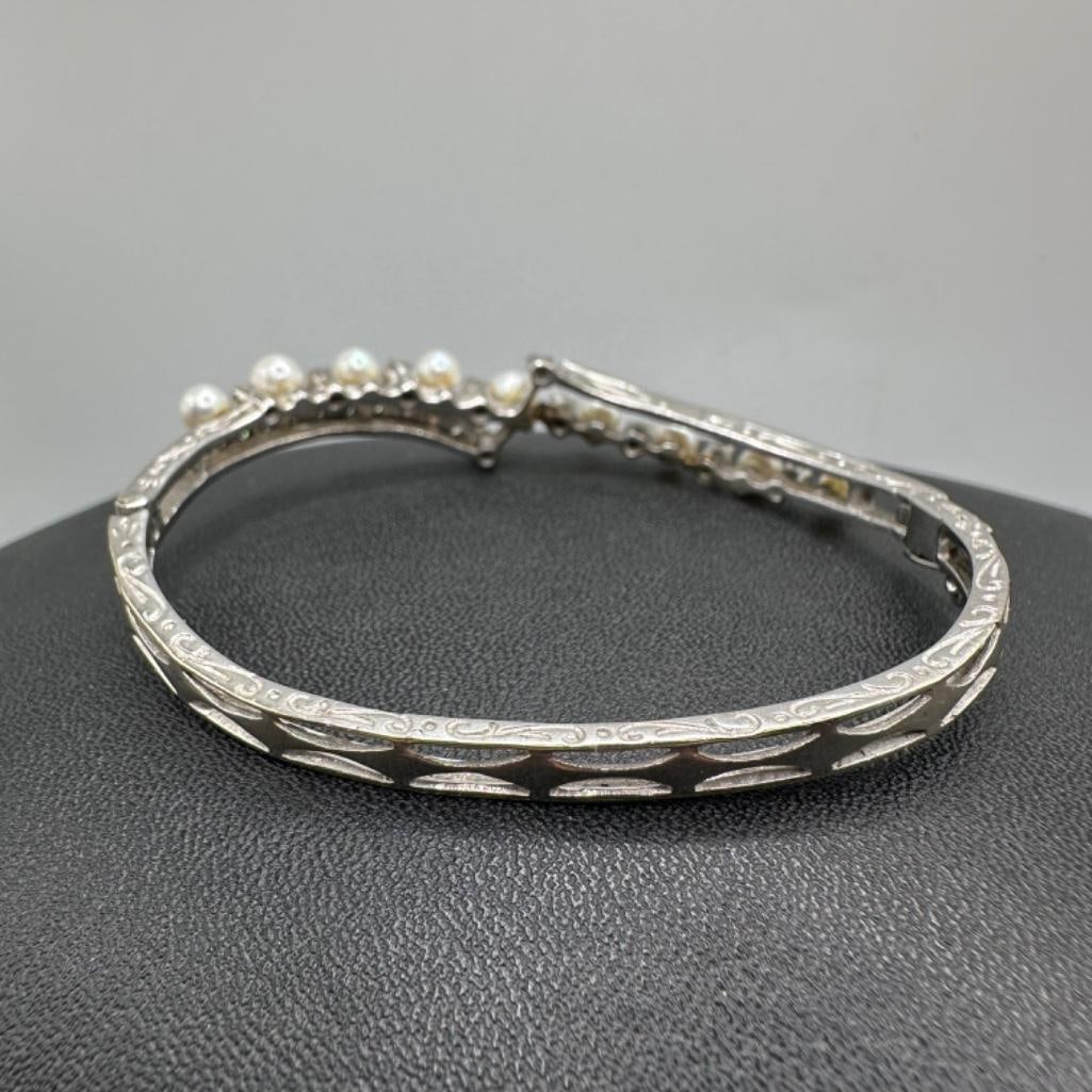 14k White Gold Diamond & Pearl Hinged Bangle: This piece of jewelry has been tested and researched prior to listing. Please view all our pictures they are part of our description. DETAILS: Metal - 14k Gold Color - White/Silver Stones - Diamond,