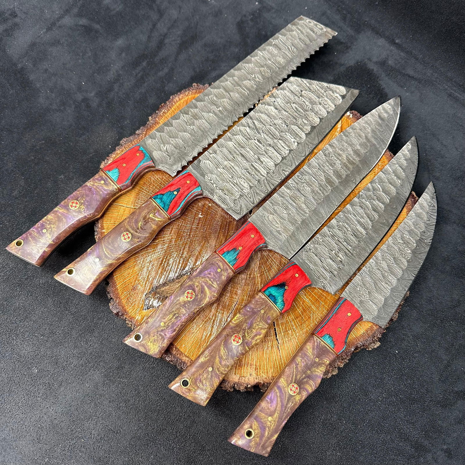 MHS Cutlery Steel Chef Knife Set 5 Knives Purple Gold Swirl Handles Q41: Set of five MHS Cutlery steel chef knives. Each knife features a patterned style blade with full tang construction, mixed wood/epoxy resin handles, and brass pins with lanyard holes. Blades show