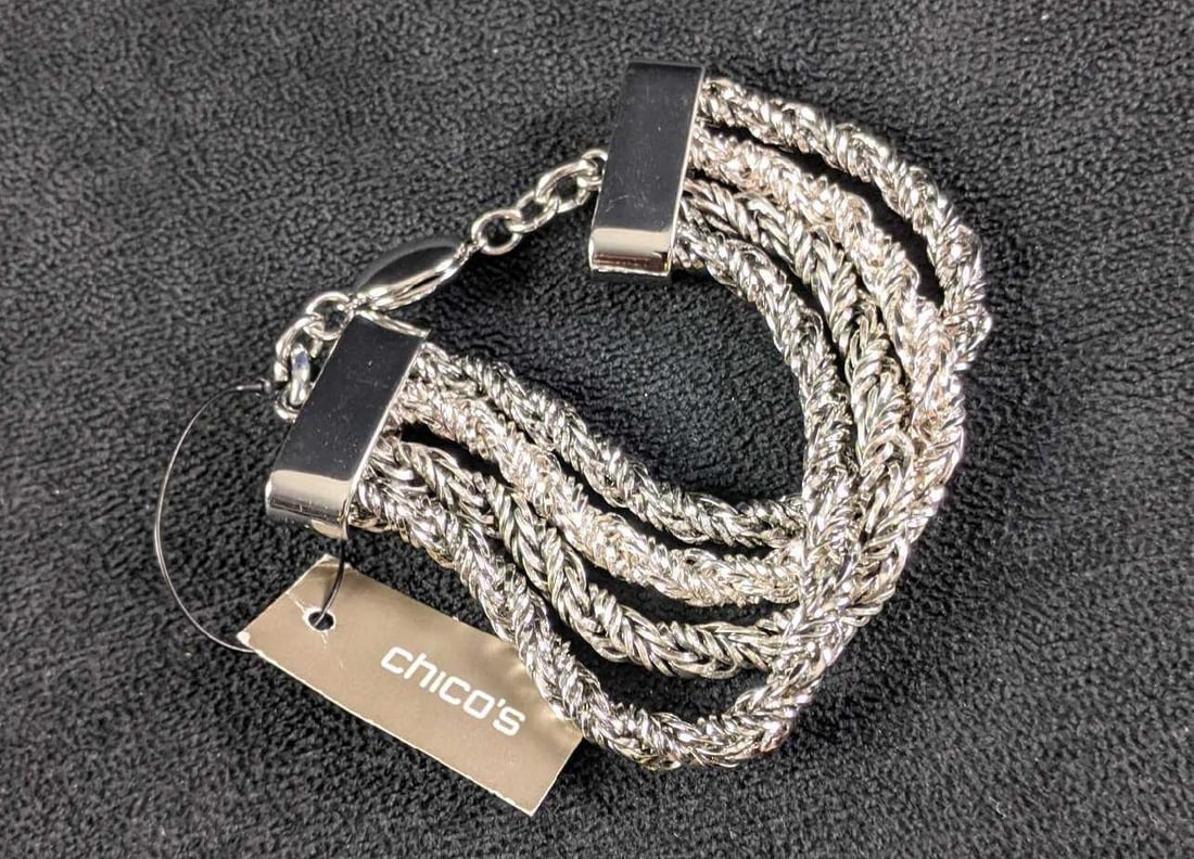 Chico's Like New Silver Colored Bracelet: This is a Chico's beautiful shiny silver-colored bracelet. This necklace is like new with its original tag. This bracelet is in great condition with a magnetic clasp to put on with ease. This is