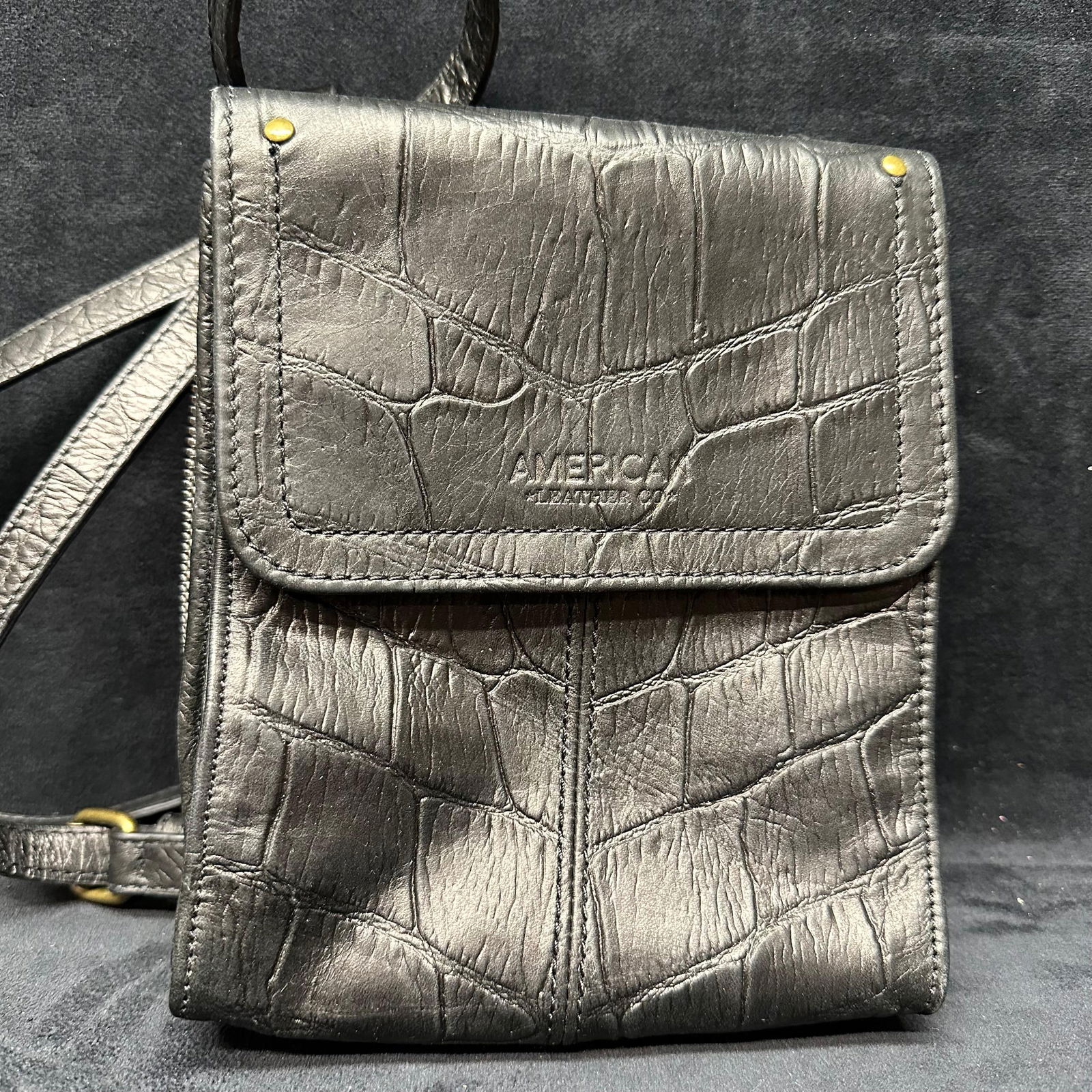 American Leather Co. Black Leather Faux Crocodile Embossed Crossbody Bag: Pre-owned condition with light surface wear consistent with normal use. Includes original dust bag. Please reference all photos for full condition details. Bag: 7 3/4" x 6 3/4" x
