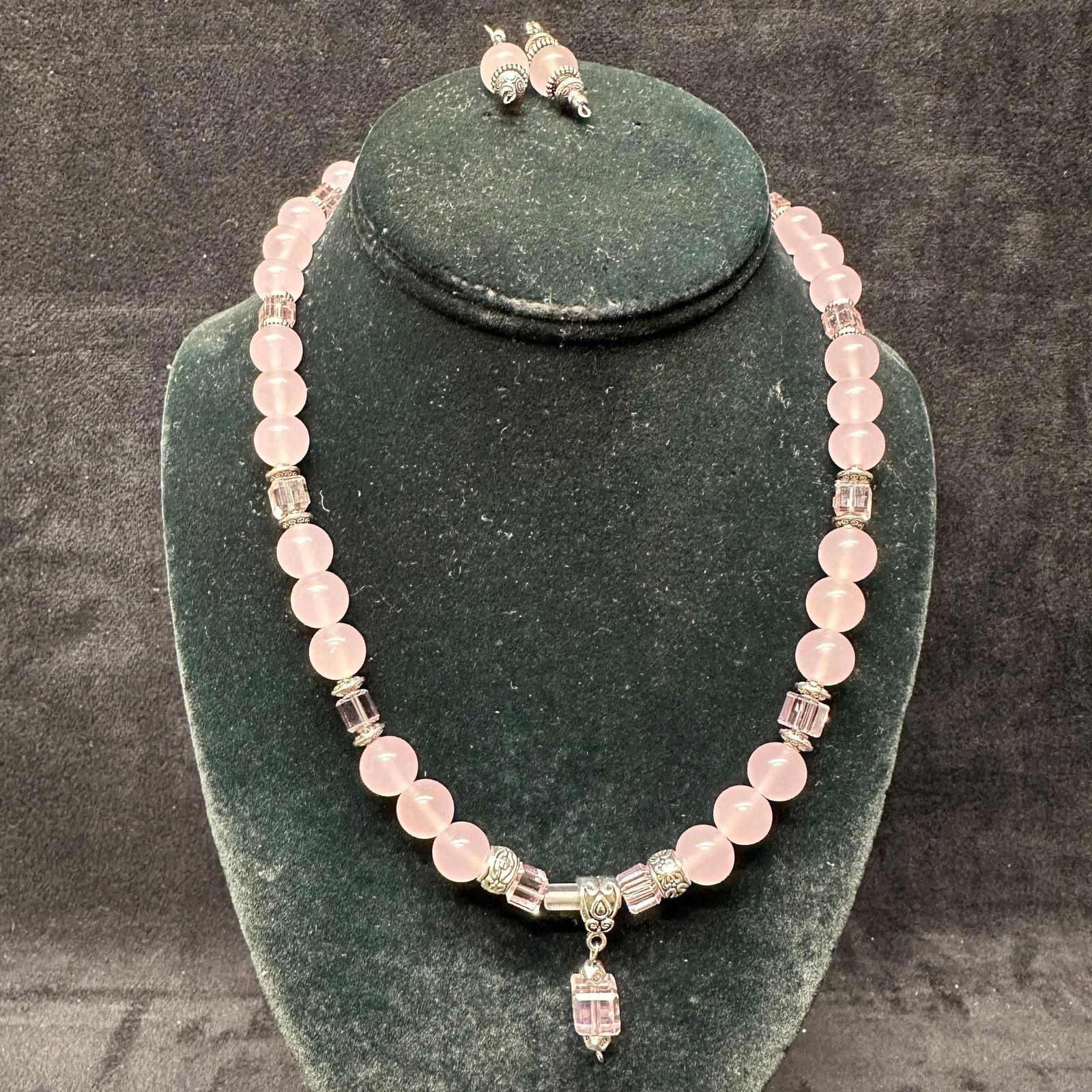 Chrystina Genuine Crystal Pink Beaded Necklace and Earrings Boxed Set: Matching necklace and earrings set by Chrystina, featuring soft pink round beads accented with faceted pink crystal spacers and decorative silver-tone fittings. The necklace includes a central drop cr