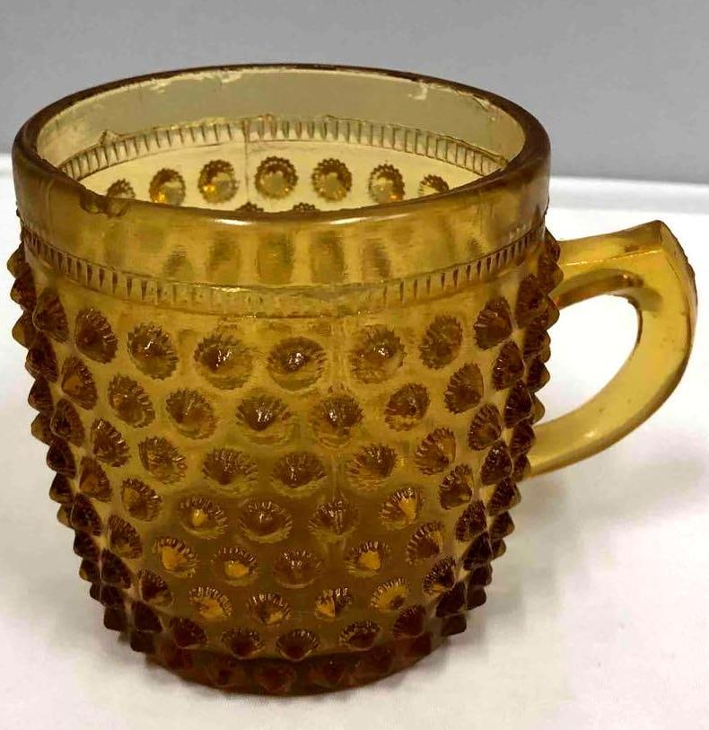 Amber Hobnail Glass Mug: This lot contains an amber hobnail glass mug. It is approx 4" x 2 1/2" x 2 3/4" and weighs about 0.3lbs. Overall the mug is in good used condition with some light ware from use over time. There are a