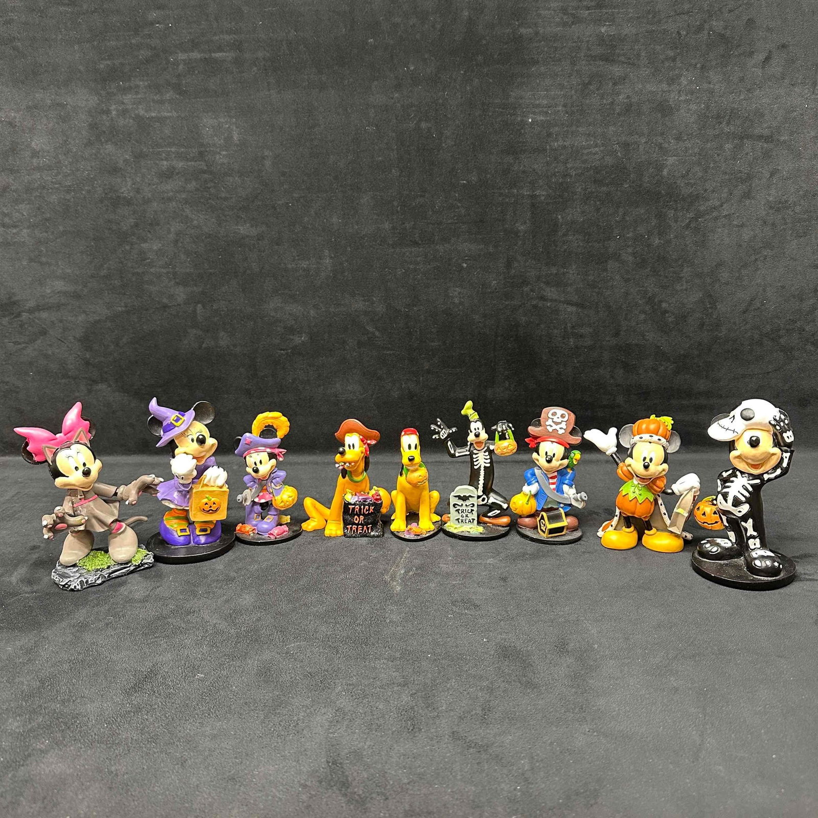 Disney Mickey Mouse and Friends Halloween Figure Set Goofy Minnie Pluto Figures: Each figure shows minor markings and staining. The Pumpkin Mickey Mouse has a break, crack in his arm. The Minnie Mouse werewolf figure has been repaired, light cracks and glue residue. These items ar