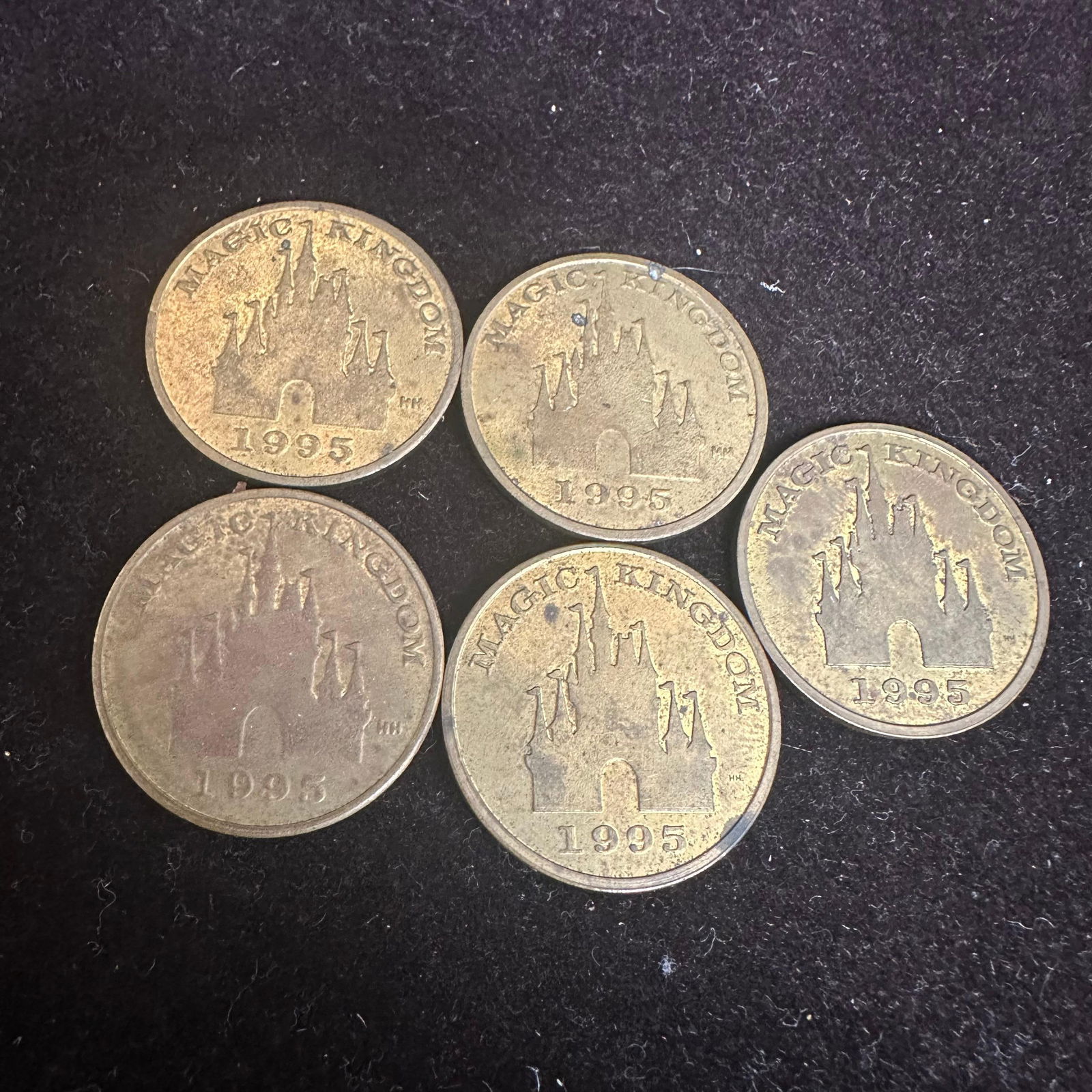 1995 Disney The Lion King Magic Kingdom Tokens Simba Nala Timon Pumbaa Rafiki Five: Group of five Disney park tokens from The Lion King, dated 1995. One side features Magic Kingdom with the Cinderella castle design and date. Reverse sides feature character portraits, including Simba,