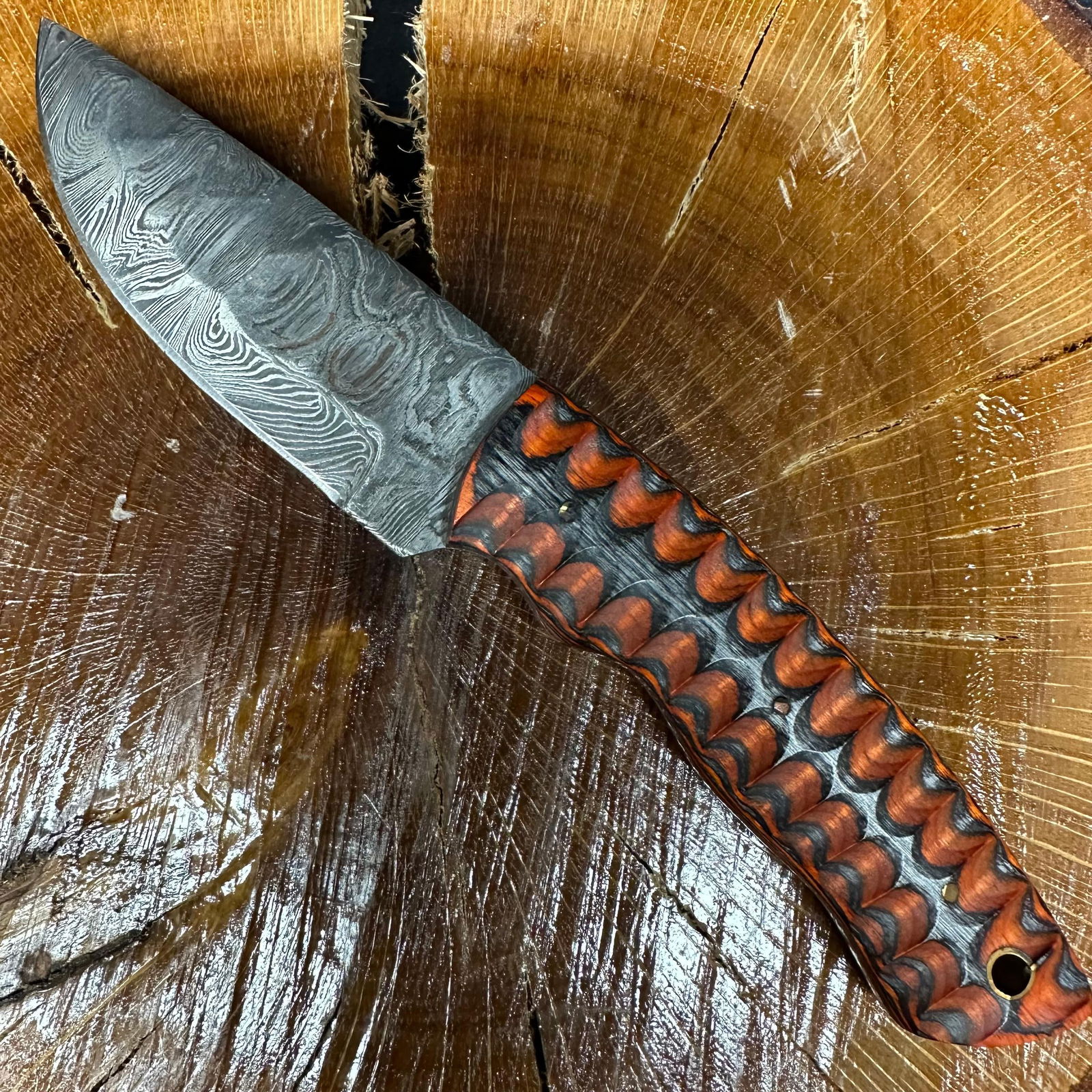 MHS Cutlery Steel Fixed Blade Knife Orange Gray Handle P35 with Sheath: Fixed blade knife by MHS Cutlery featuring a patterned steel blade. The handle is constructed with multi-tone stabilized material in orange and gray hues, accented with mosaic pins and a lanyard hole