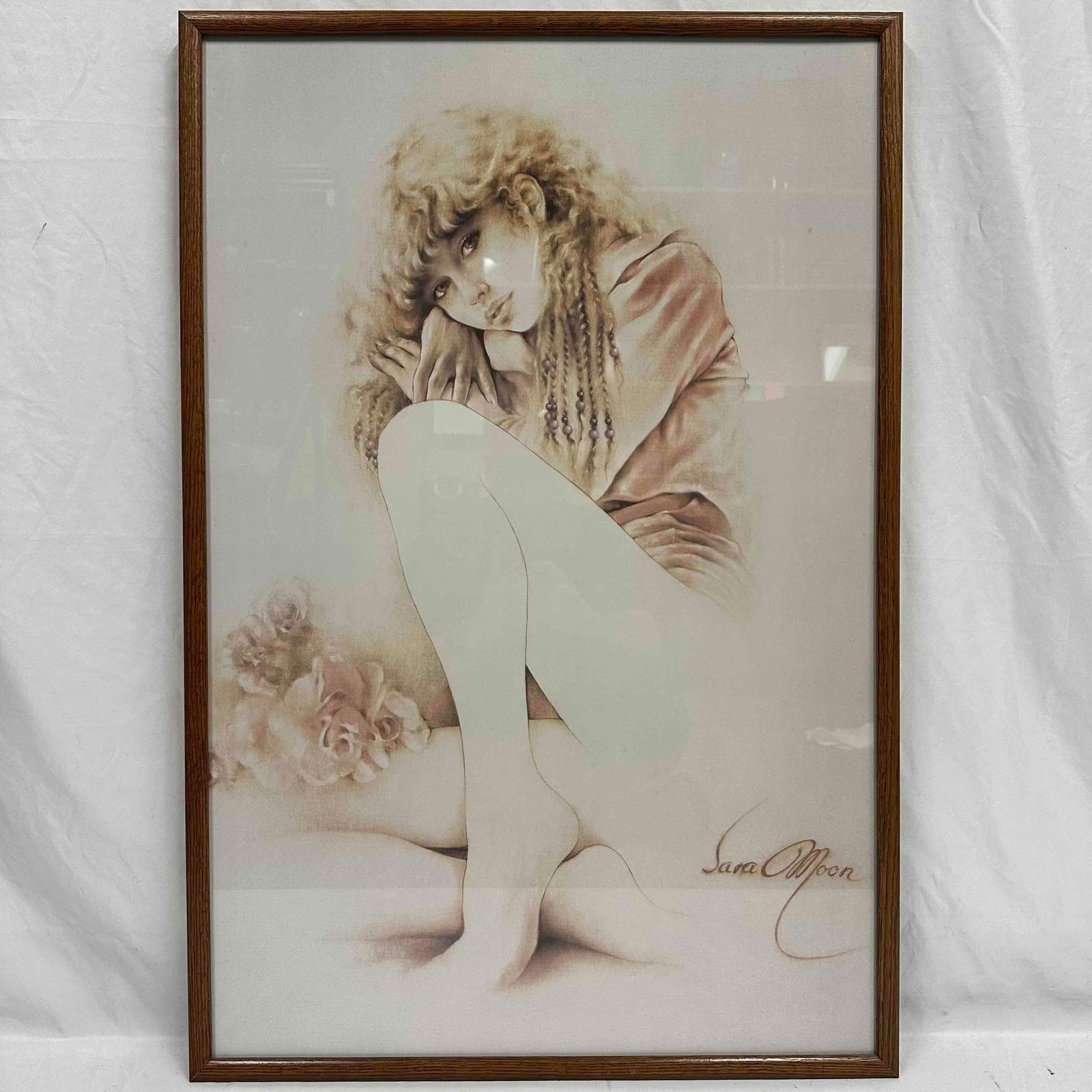 Sara Moon Framed Art Print Seated Girl Portrait Tristesse Framed: Vintage Sara Moon art print depicting a seated young woman with long curly hair and roses at her side. Print signed in the image lower right. Presented in a wood frame under glass with paper backing a