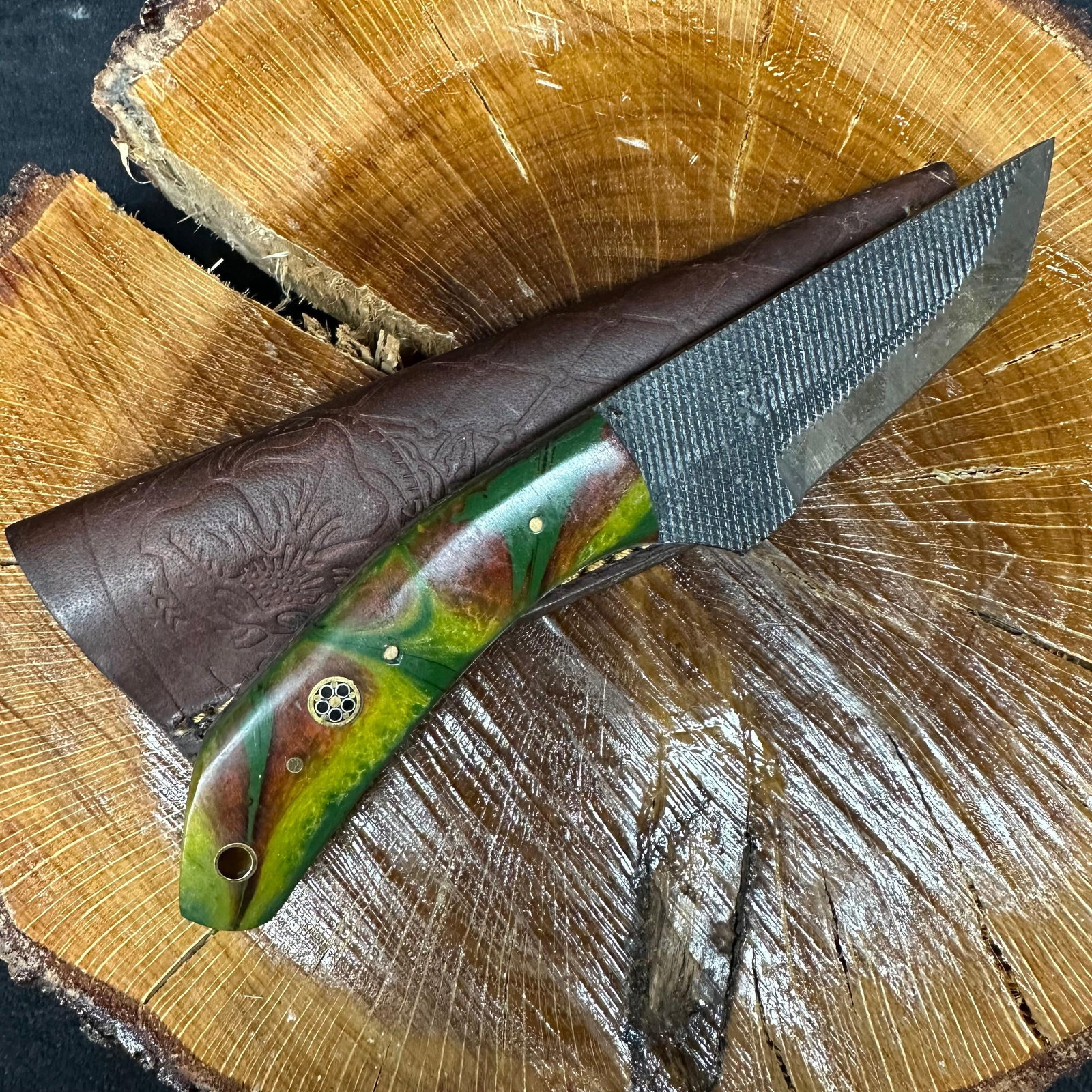 MHS Cutlery Steel Blade Knife Brown Green Camo Style Handle P65: Fixed blade knife by MHS Cutlery featuring a textured patterned steel blade. The handle features a contoured, multi-colored camouflage colorway wood/epoxy resin-style grip with metal mosaic pin accent