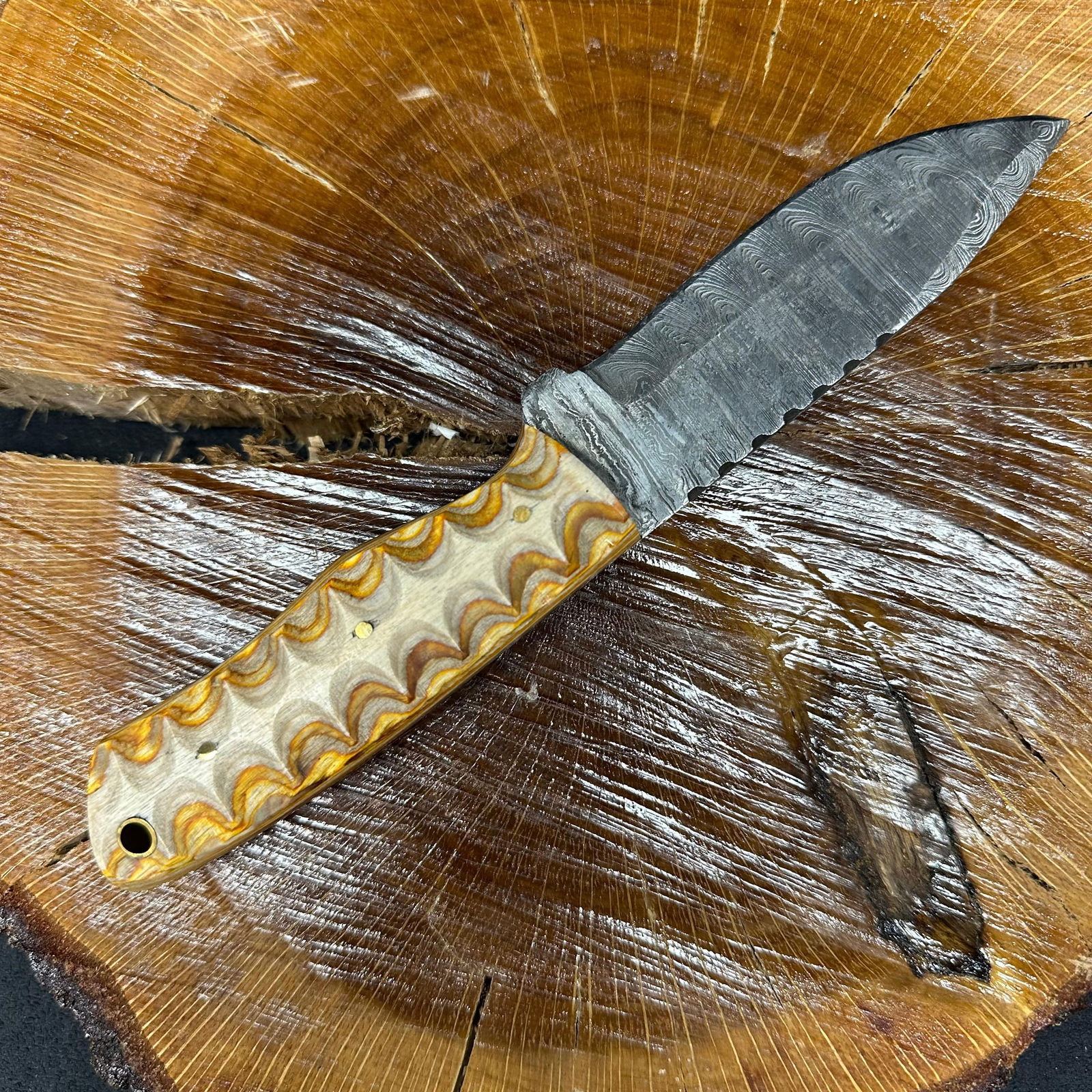 MHS Cutlery Fixed Blade Knife P90 with Leather Sheath: Fixed blade knife by MHS Cutlery featuring a layered pattern steel blade and decorative spine work. The handle has a contoured, multi-colored wood/epoxy resin-style grip with metal mosaic pin accents.