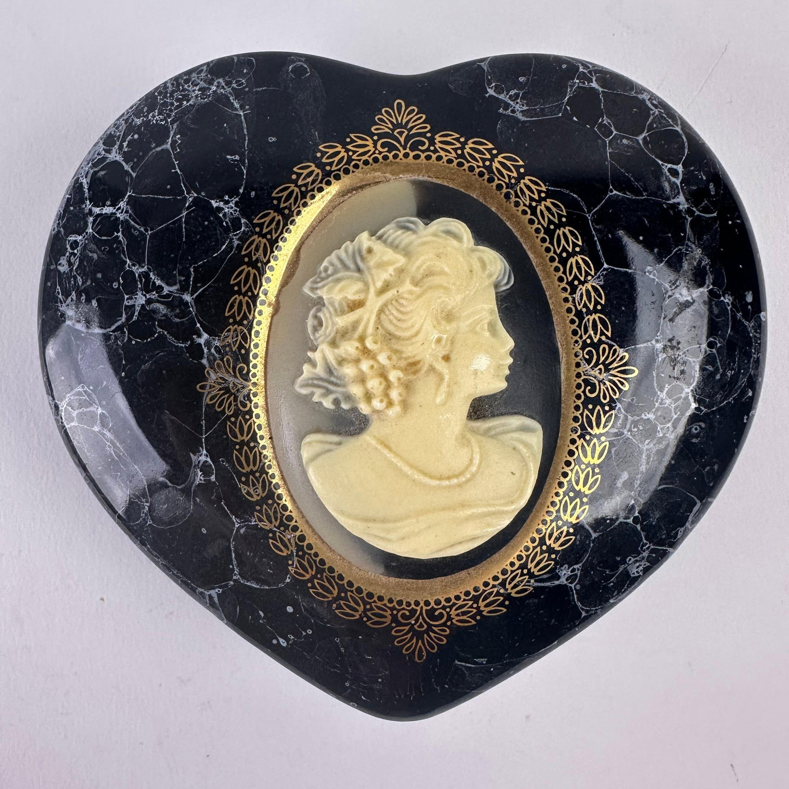 Cameo Black Marbled Style Heart Shaped Ceramic Trinket Box Made In Japan: Charming black heart-shaped ceramic trinket box featuring a raised cream beige colored cameo portrait framed with intricate gold detailing. The box has a marbled style finish with a removable lid and