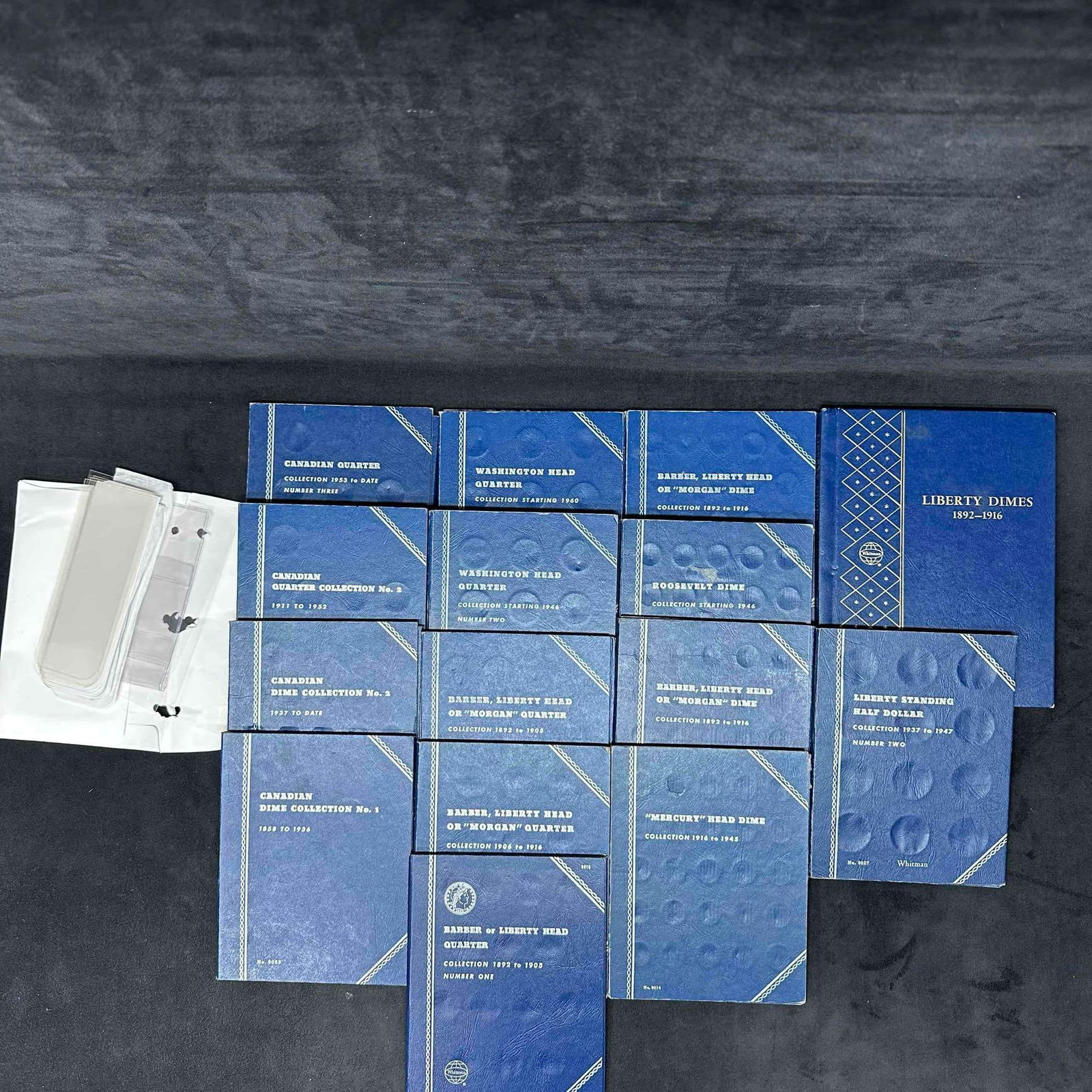Coin Collector Folder Album US and Canadian Coins Holder Set Whitman Accessories: This set of coin collector folders includes 16 Whitman Company coin holders for Canadian and US Coins. Also an envelope with some more coin collector accessories. These items are in good pre-owned,