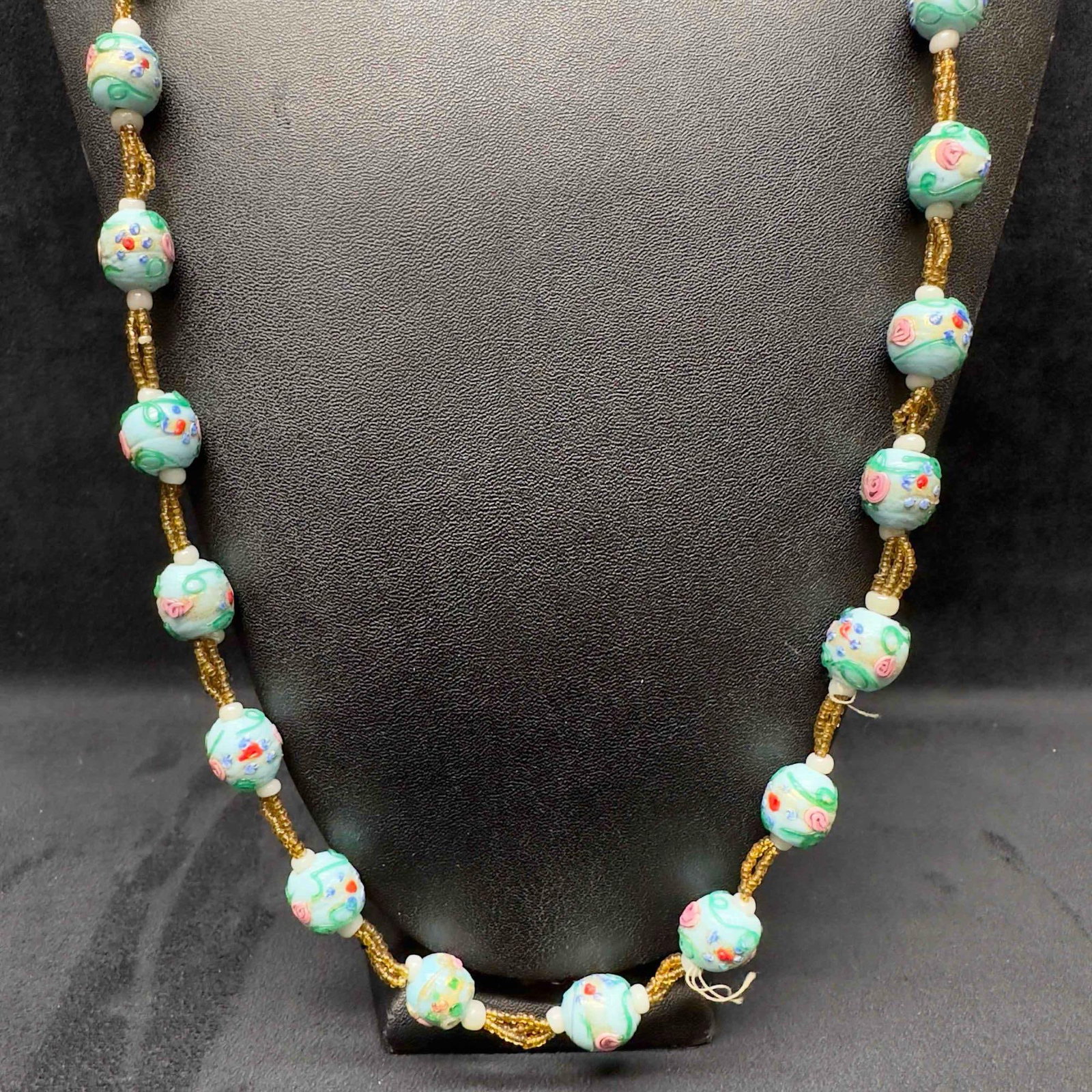 Venetian Murano Art Glass Lamp Work Light Blue Floral Yellow Beaded Necklace D15: Venetian Murano Art Glass Lamp Work Light Blue Floral Yellow Beaded Necklace D15. Necklace with light blue colored glass beads with beautiful designs on each. The necklace features floral accents. Loo