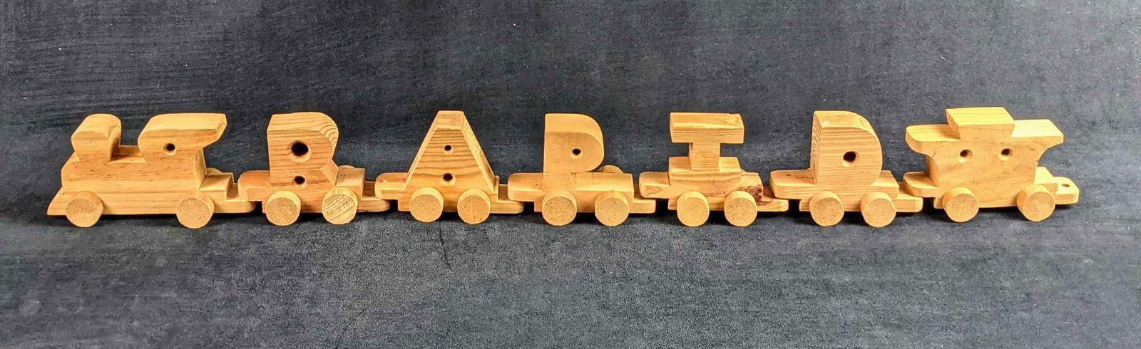 Vintage Hand Carved Wood Alphabet Train: Vintage Hand Carved Wood Alphabet Train. Comes with nearly all of the letters with the exception of J, M, and V. Wood is nice and heavy. The maker and date of creation are unknown. Comes with an