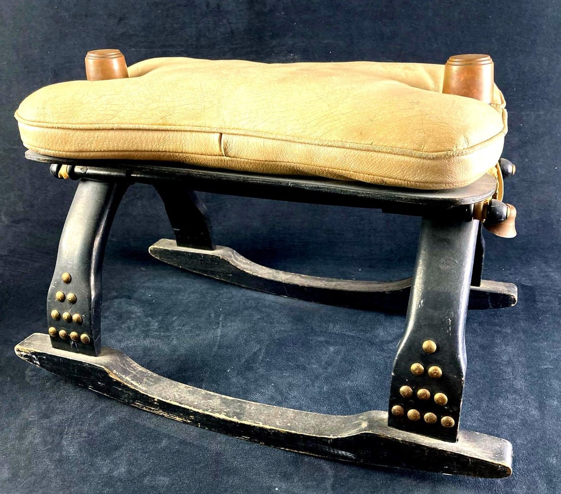 Egyptian Camel Saddle Rocking Chair: Up for auction is a recent estate find, an Egyptian camel saddle rocking chair found amongst a collection of items from around the world. The saddle seat is made of leather and there is a bell on the