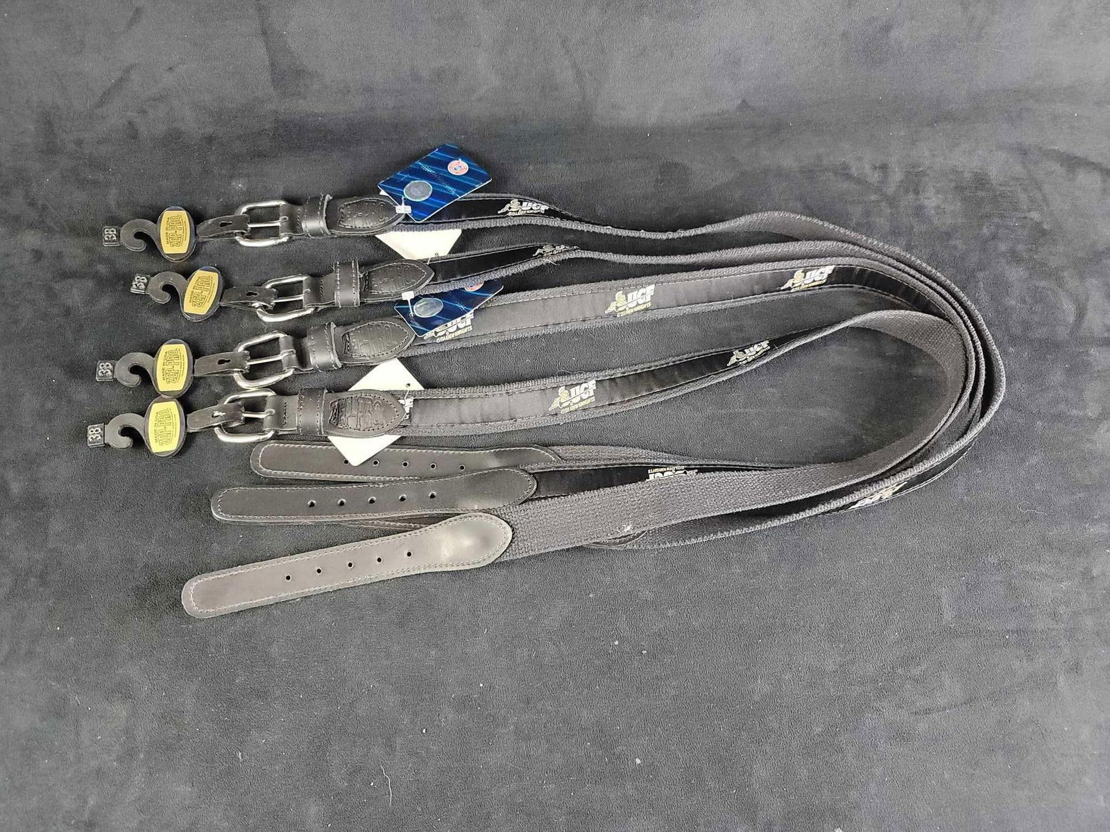 UCF College Football Black and Gold Knight Belts G: This lot contains 4- 38" black and gold colored with knight logo belts, with leather and solid brass buckles. Belts are unused with tag. Weights of all the belts 0.9 lbs