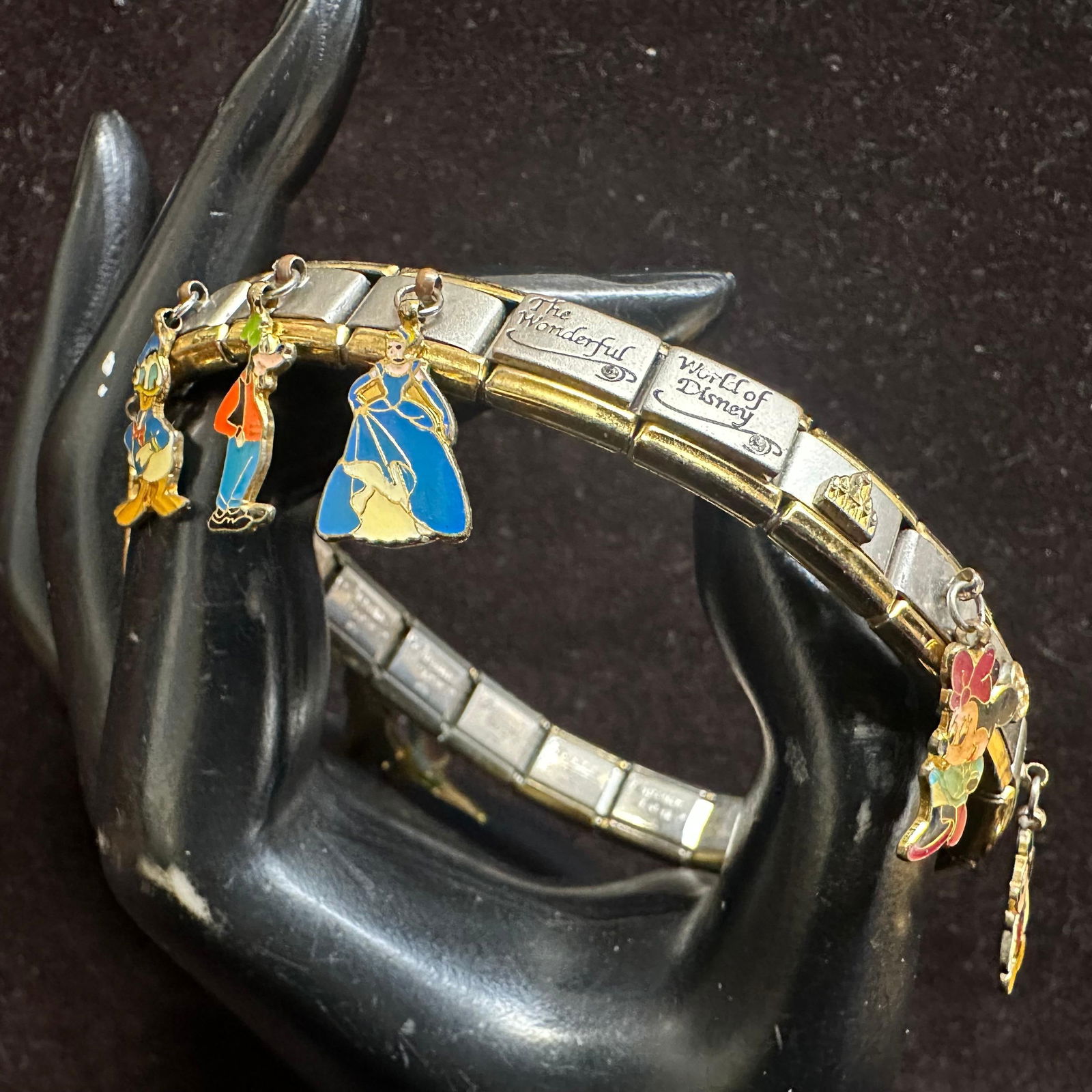 Bradford Charming Touches Wonderful World of Disney Stretch Charm Bracelet: The Bradford Charming Touches Wonderful World of Disney Stretch Charm Bracelet is a delightful decorative collectible featuring various charms inspired by the iconic Disney characters. Made of metal i