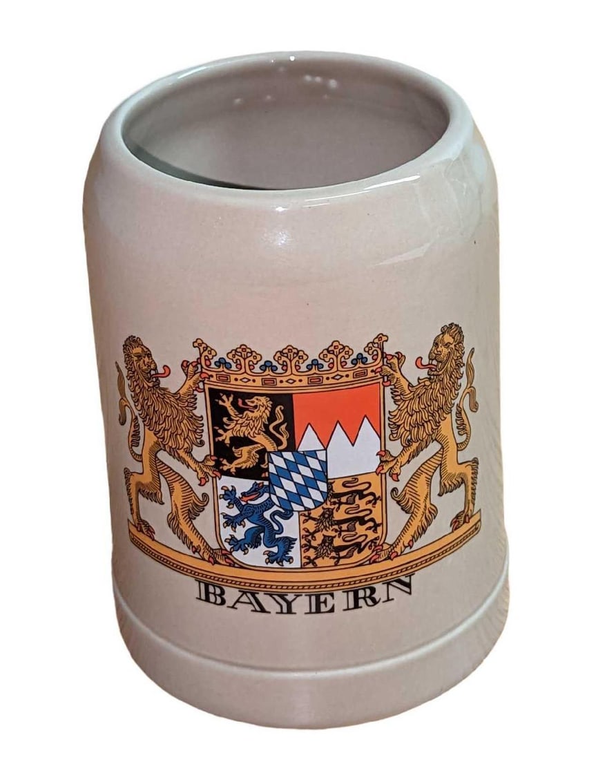 Ceramic Germany Bayern Souvenir Stein: Ceramic Germany Bayern Souvenir Stein. This stein or mug is approximately 5 1/4" x 4" x 5 1/4" and weighs 1.64lb. The stein is in good, used condition with some signs of wear on the bottom