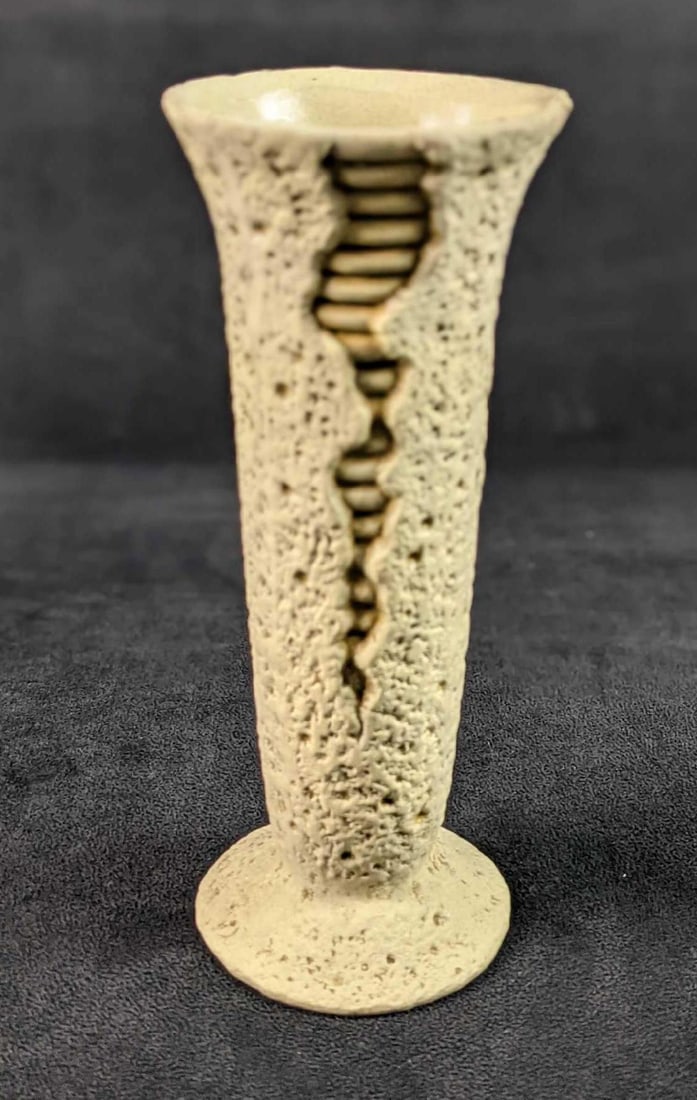Vintage Ceramic Vase Cracking Textured: Vintage ceramic vase that was made to appear to be cracking open to reveal another layer underneath. The vase is fully textured and is approx 3" x 3" x 8 1/4". The vase is in a good, vintage condition