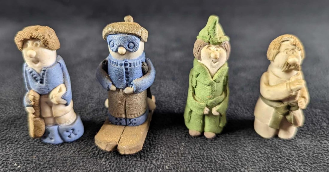 4 Vintage Hand Made Clay Little People Figures: This lot includes: Karate Guy. This is approx 3/4" x 3/4" x 2". Has a chip on its hair.Army Lady. This is approx 3/4" x 3/4" x 2 1/4".Tennis Player. This is approx 7/8" x