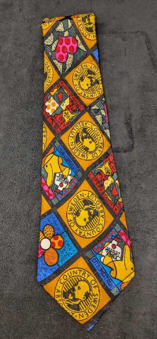 Absolut Vodka Romero Britto Silk Tie New B: Absolut Vodka Romero Britto Silk Tie New B. 100% silk tie designed by Romero Britto, for Absolut Vodka in the 1990s. This silk tie is still in the original packaging and has never been used or worn.
