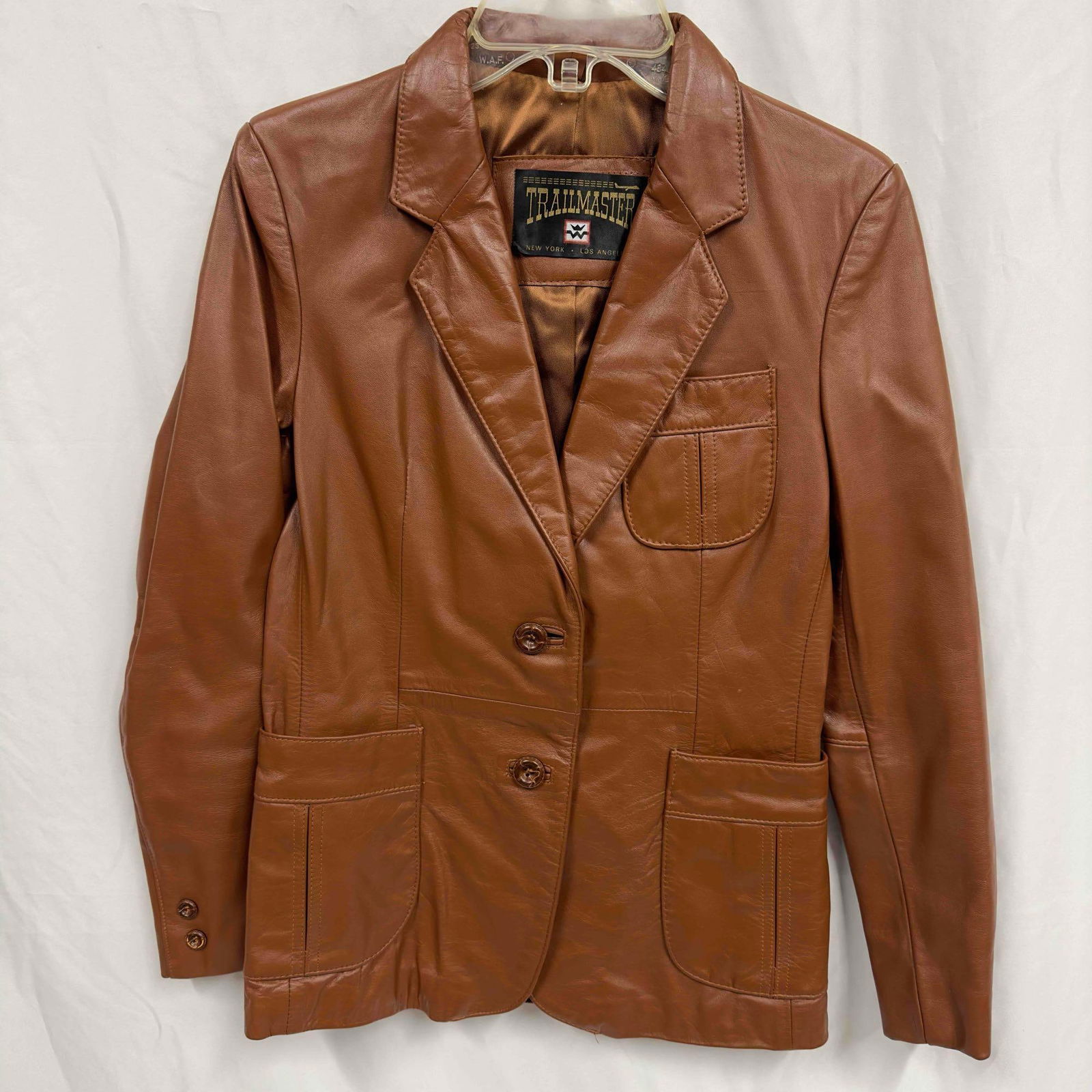 Trailmaster Women's Brown Jacket Medium: Trailmaster Women's Brown Jacket Medium. This jacket has a simple brown design with a two button closure on the front. Three pockets are located on the front of the jacket. Some original tags