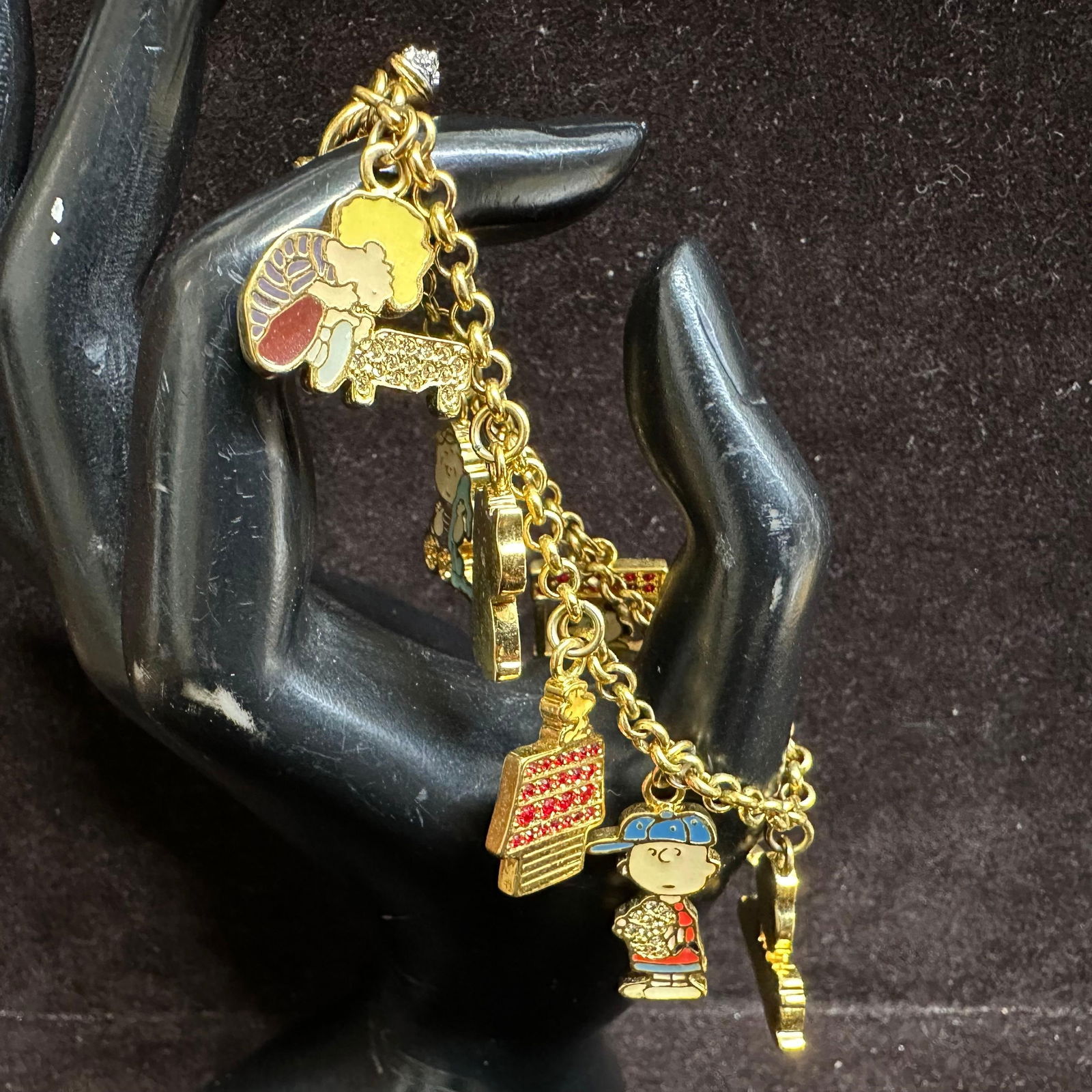Peanuts Charm Bracelet Snoopy Charlie Brown Metal Enamel Multicolor UFS: Peanuts charm gold-toned bracelet featuring characters including Snoopy, Charlie Brown, Lucy, Woodstock, Linus, and more. Multicolored enamel and rhinestone accents. This item is in good pre-owned,