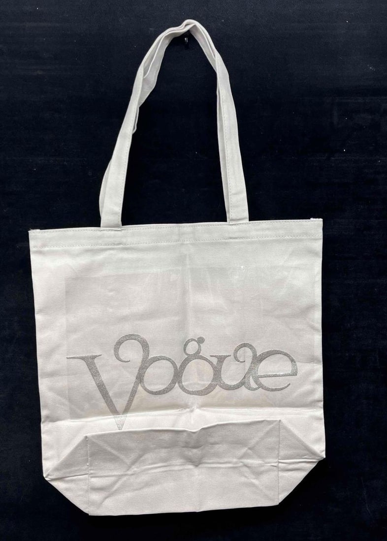 Vogue Limited Edition Canvas Tote Bag With Silver Metallic Logo From The Archive: This lot contains a Vogue Limited Edition Canvas Tote Bag With Silver Metallic Logo From The Archive. This Limited edition tote features a logo that first appeared on the cover of the January 1st