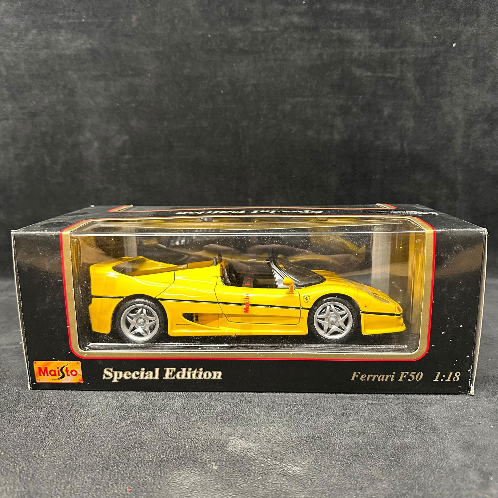 Maisto Special Edition Ferrari F50 1995 1:18 Scale Die-Cast Model Car: Maisto Special Edition 1:18 scale die-cast model of the Ferrari F50 1995. Yellow exterior with detailed interior. Die-cast metal with plastic parts. Features include opening doors, hood, and rear engi