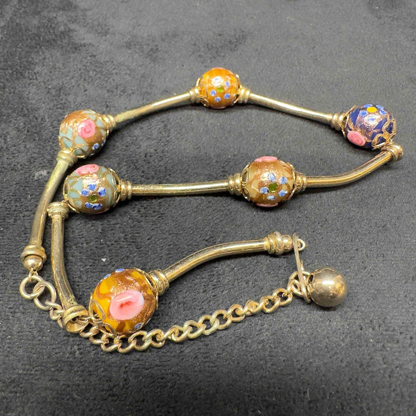 Venetian Murano Lamp Work Art Glass Bead Multi Colored Beaded Necklace B52: Venetian Murano Lamp Work Art Glass Bead Multi Colored Beaded Necklace B52. Necklace with multi colored glass beads with beautiful designs on each. The necklace features copper and floral accents.