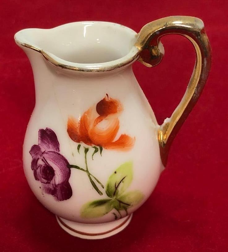 Miniature Floral Ceramic Water Pitcher Gold Accent: This lot contains a Miniature Floral Ceramic Water Pitcher with Gold Trim Accents. It is approx 2-1/4" x 2" x 1-1/2" and weighs about 0.1lbs. Overall the Miniature Pitcher is in good used condition wi