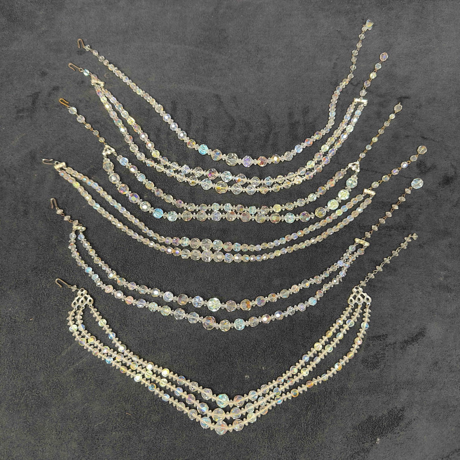 Costume Jewelry Clear Glass Crystal Faceted Beaded Multi Strand Necklace Set Lot of Six I20: Costume Jewelry Clear Glass Crystal Faceted Beaded Multi Strand Necklace Set Lot of Six I20. Necklaces with clear crystal glass beads with beautiful designs. Each necklace features a j hook clasp