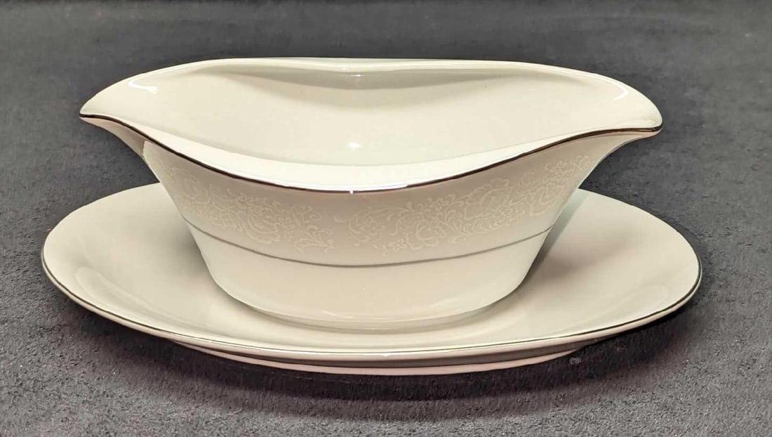 Retired International Juliet Gravy Boat With Underplate: Retired International Juliet Gravy Boat With Underplate. This is approx 9 1/4" x 6" x 3 1/4" and it weighs 1.07lb. Made of fine china. Please note, that the underplate is attached to the gravy boat