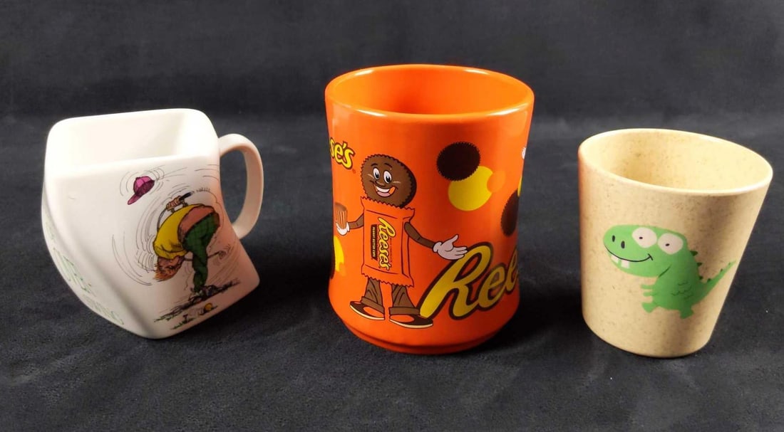Three Novelty Mugs And Glass Reeses Gator Golf: This lot includes: (1) Crazy shaped Golf "The Results Of Over-Swing". Golfer twists himself after a very strong swing. The mug is oddly shaped like the poor golfer's back. Made by Golf Gi