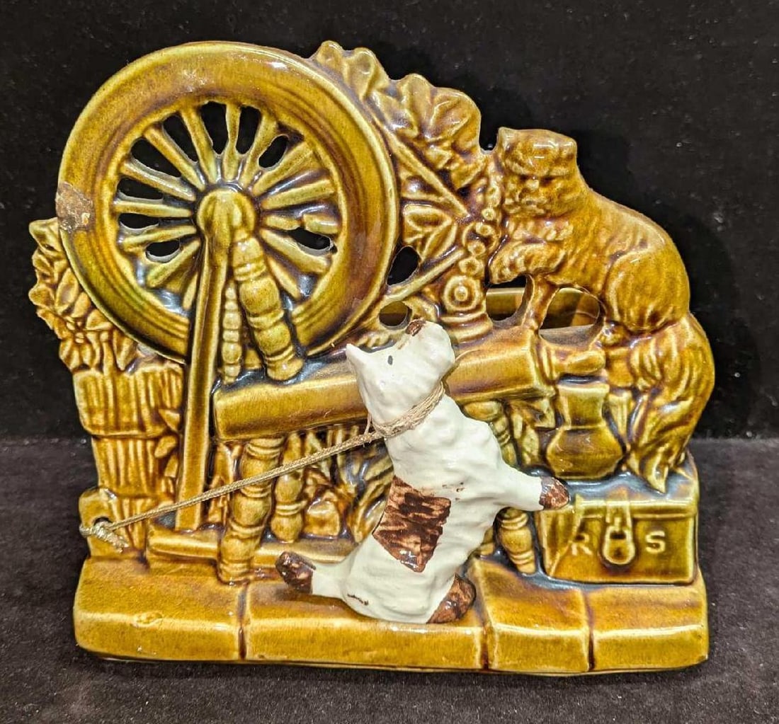 McCoy Sewing Wheel And Dog Ceramic Planter: McCoy Sewing Wheel And Dog Ceramic Planter. This is approx 7 1/4" x 4 1/4" x 6 5/8" and it weighs 2.76lbs. The planter has some crazing, imperfections (blisters) on the bottom and some residue inside