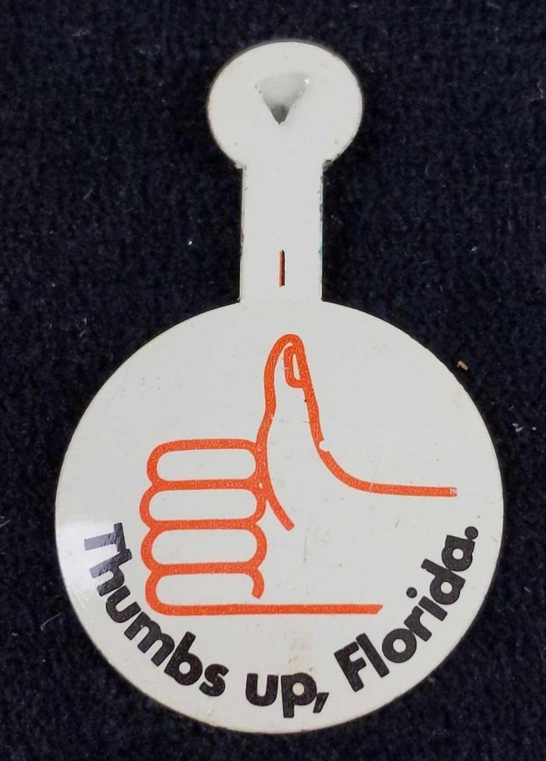 27 Vintage Thumbs Up Florida Tin Buttons: Here are twenty-seven tin "Thumb's Up Florida" tin pins. Pins are in good, vintage condition with some pins having some wearing. Pins are approx 1" x 2".
