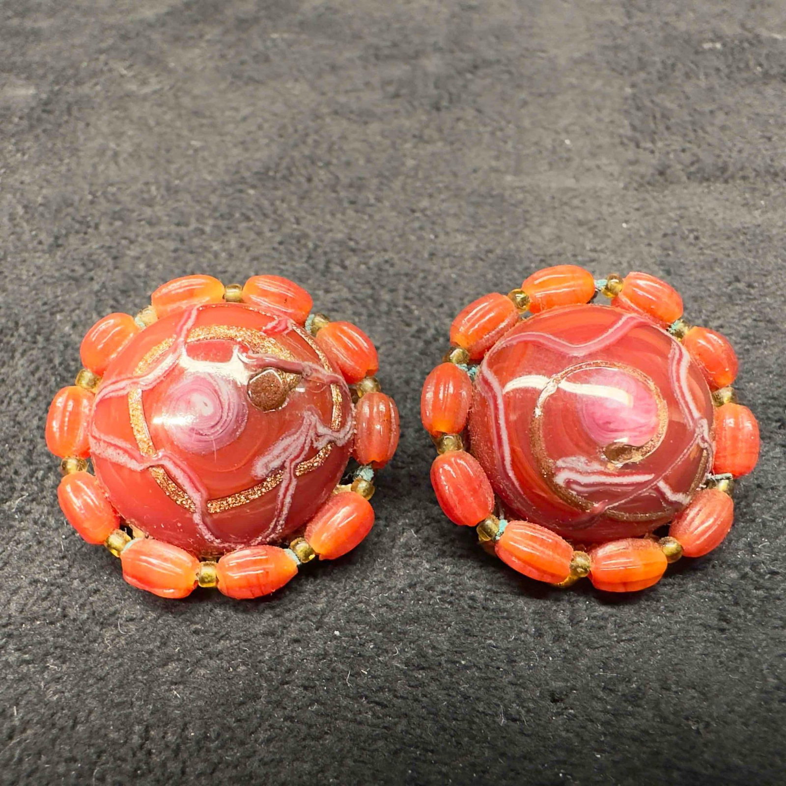 Murano Venetian Art Glass Lamp Work Red Round Beaded Earrings D32: Murano Venetian Art Glass Lamp Work Red Round Beaded Earrings D32. Earrings with red glass beads with beautiful designs on each. The earrings feature copper swirl accents. The earrings feature a