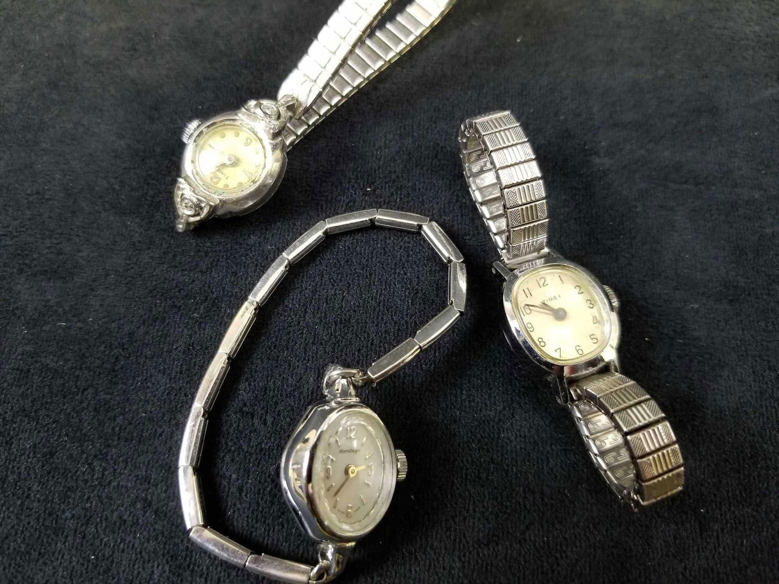 Lot of 3 Vintage Womens Watches: This vintage lot of 3 Women's watches features: Timex. This watch is in good used condition with some scuffing on band and bezel as well as scratches on glass surface. The elastic band is in