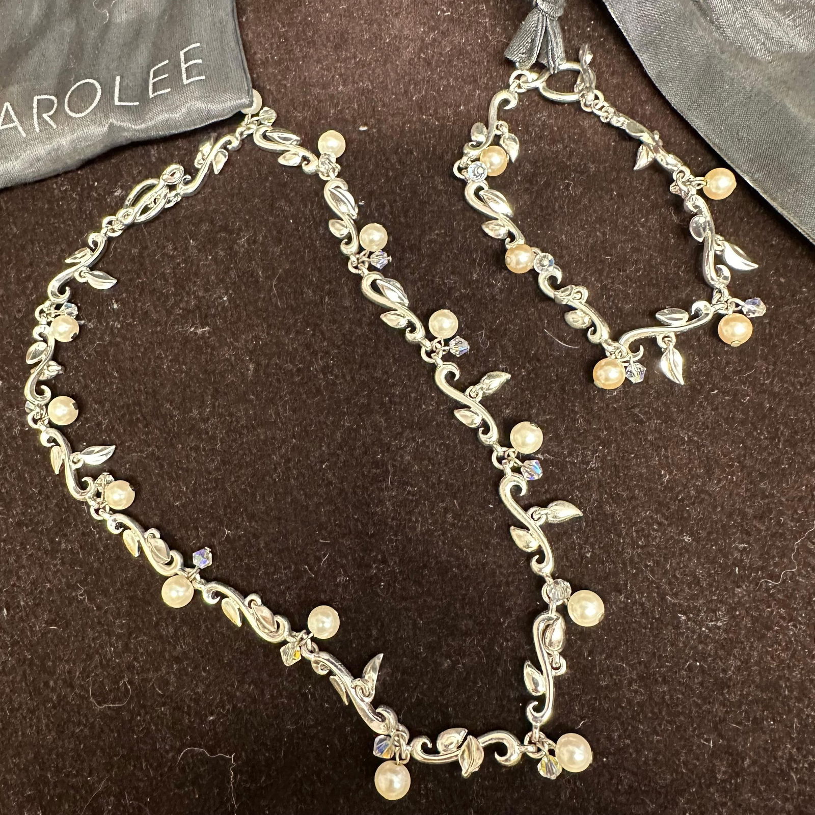 Carolee Silver Plated Floral Faux Pearl Design Necklace and Bracelet Set: Each piece includes a Carolee dust jacket bag. These items are in pre-owned, previously displayed condition with light wear and surface markings. Please reference all photos for full details. 