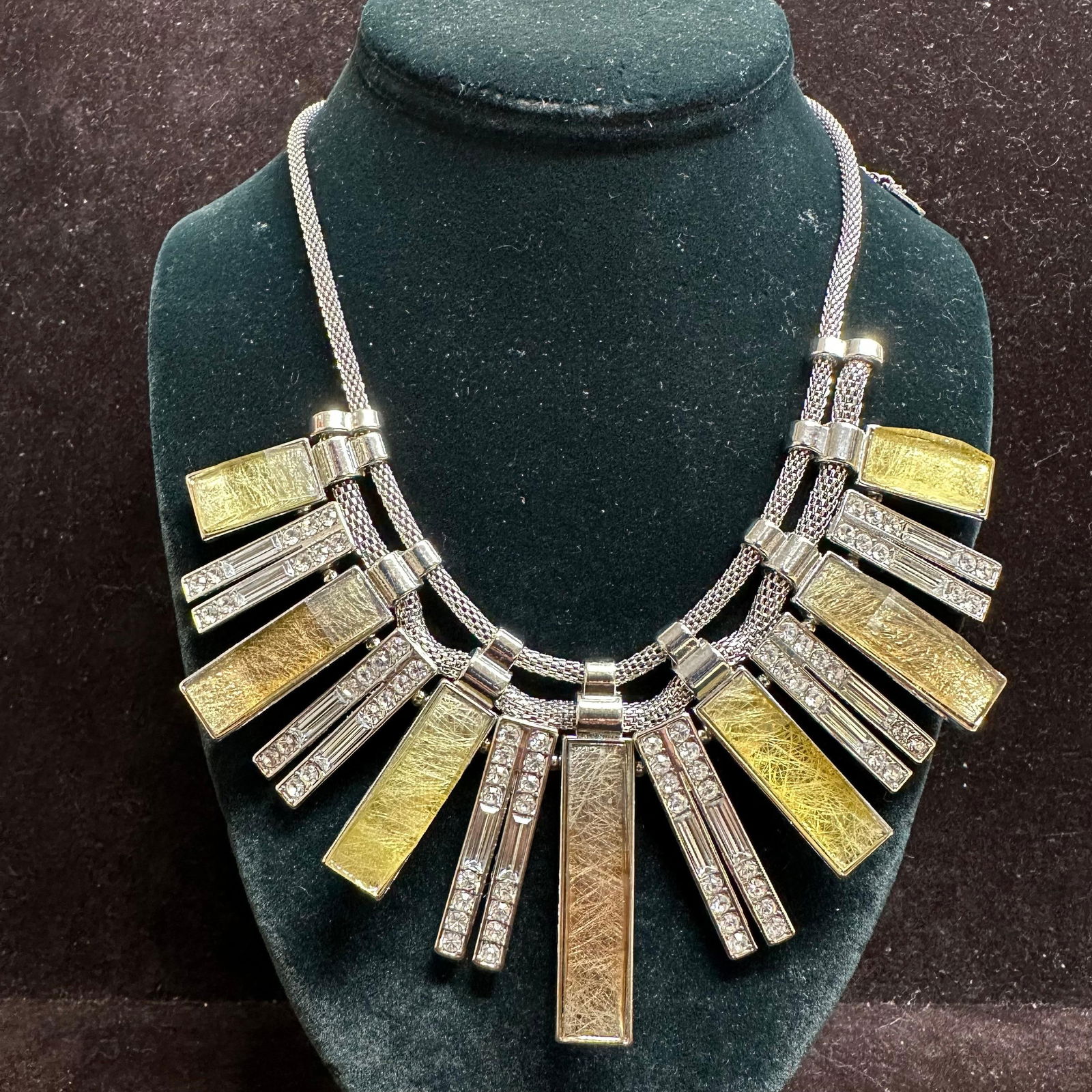 Jenifer Lopez Statement Necklace with Silver-Tone Mesh Rhinestone Bar Drops: Jenifer Lopez J Lo brand Modern statement necklace featuring a multi-strand silver-tone mesh chain with alternating gold-tone rectangular bar drops and clear rhinestone-set bar accents. This item is