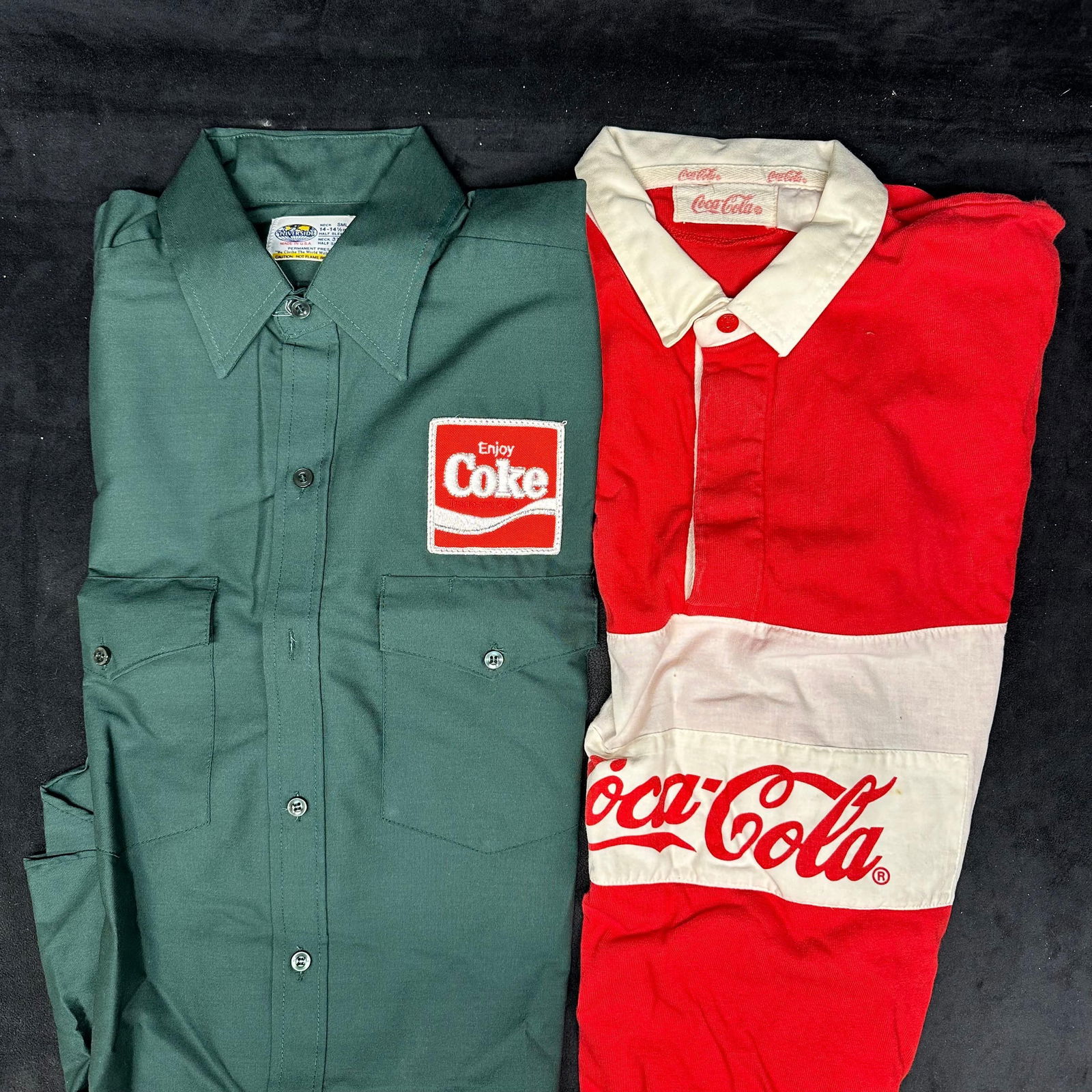 Coca Cola Promotional Shirts Green Work Shirt and Red Rugby Style Polo: Two vintage Coca-Cola-branded shirts. Includes one green short-sleeve button-front work shirt with an embroidered Enjoy Coke patch on the chest, and one red and white rugby-style short-sleeve polo wit