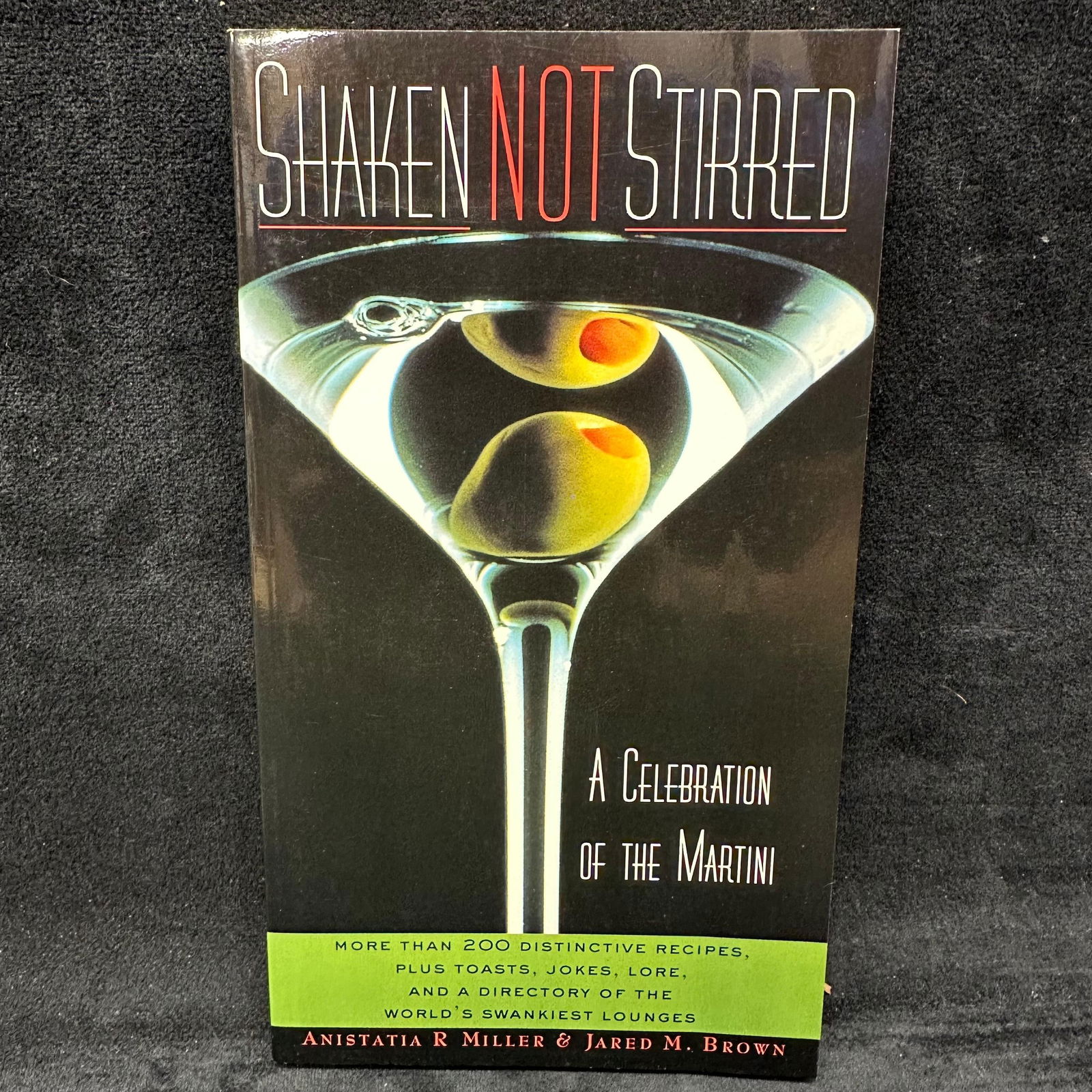 Shaken Not Stirred A Celebration of the Martini Softcover Book Signed: Signed with a personal inscription to Michel Roux. Condition shows general handling wear, scuffing, and surface marks to the cover consistent with age. Interior pages appear intact. This item is