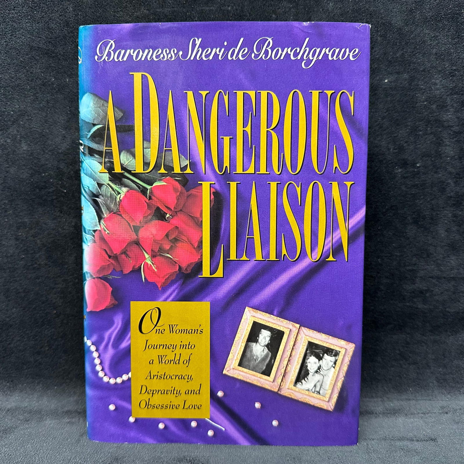 A Dangerous Liaison Baroness Sheri de Borchgrave Signed Hardcover Book: Signed by Baroness Sheri de Borchgrave with a personal inscription to Michel Roux. Condition shows general handling wear, scuffing, and surface marks to the cover consistent with age. Interior pages
