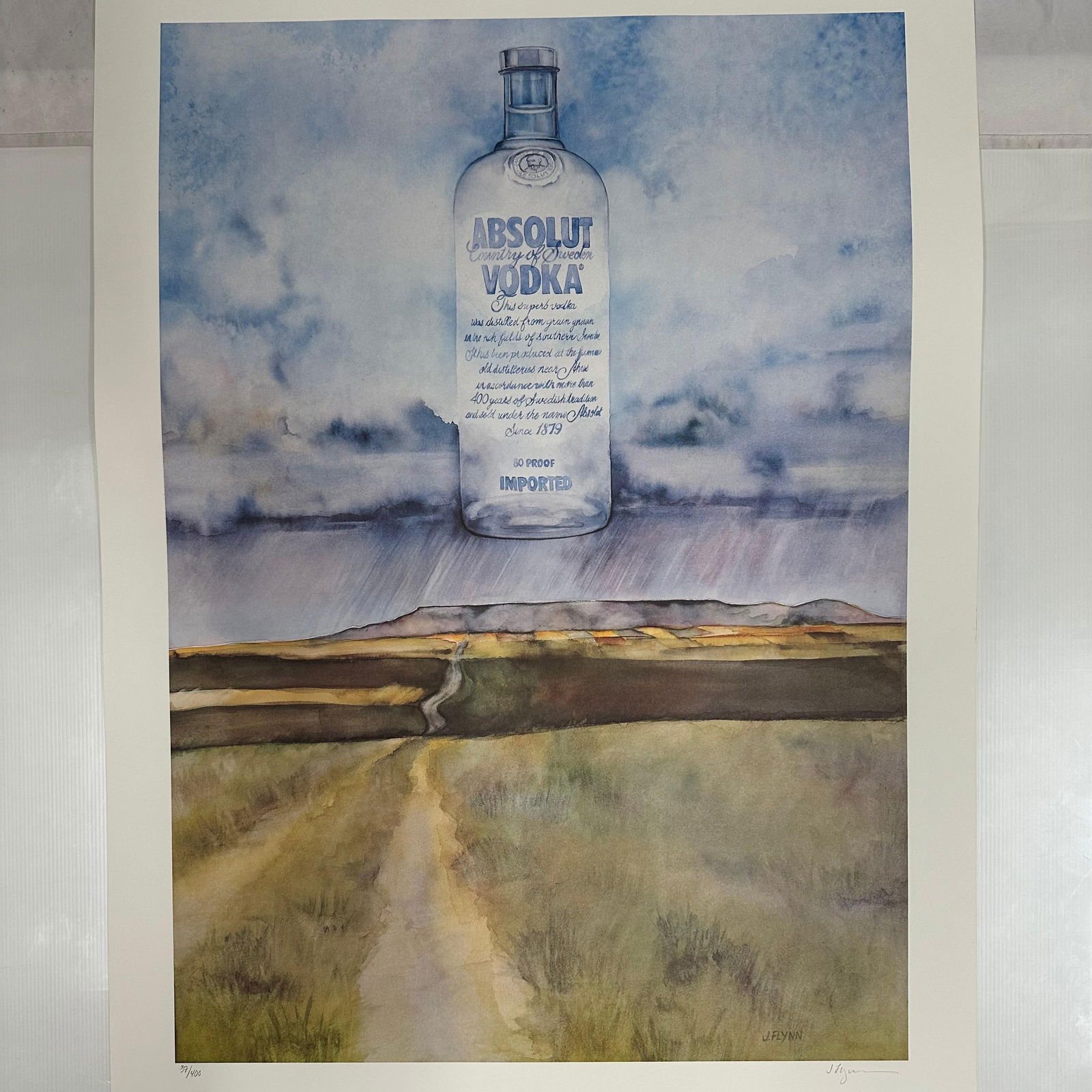 Absolut Vodka Statehood North Dakota Joe Flynn Print 37/400 Signed and Numbered: Limited edition Absolut Vodka “Statehood” lithograph print on paper. Features the iconic Absolut bottle incorporated into a stylized North Dakota-themed landscape composition. Hand-signed