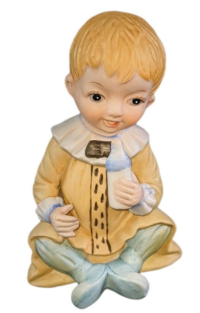 Vintage Ceramic Baby Boy Figurine: Vintage Ceramic Baby Boy Figurine. The maker and date of creation are unknown. The figurine is approx 4" x 4" x 7" and it weighs 0.55lb. The figurine is in good, vintage condition with some wear on