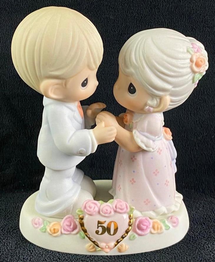Precious Moments "We Share A Love Forever Young": Precious Moments "We Share A Love Forever Young" 50th wedding anniversary figurine from Precious Moments. The title is "We Share A Love Forever Young". It shows two figures above a